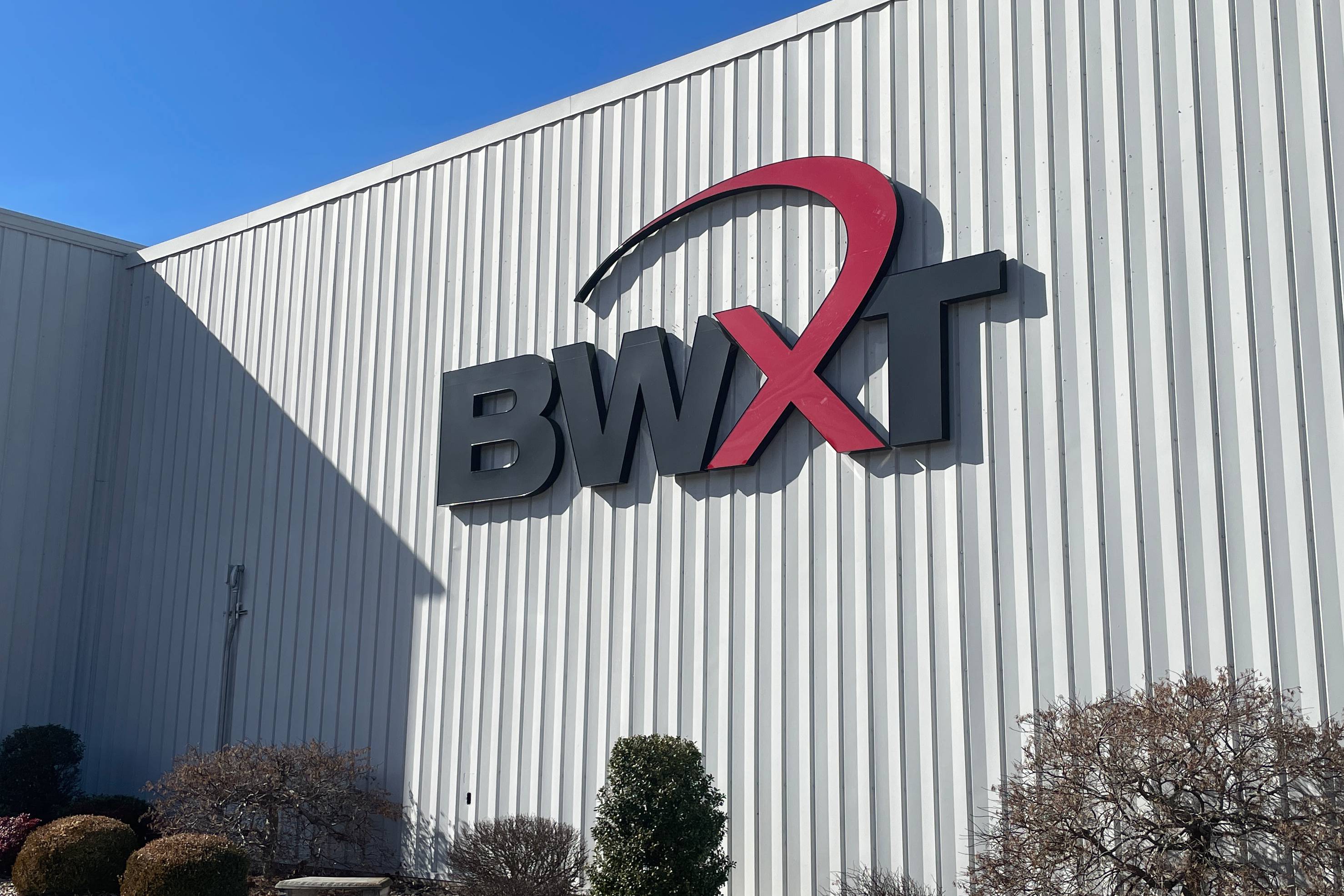 A white building with a large BWXT logo on the outside. 