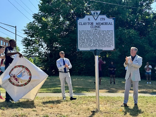 Jordan Bell, Clayton Claytor and Nelson Harris clap as the Clayton Memorial Clinic historical marker is unveiled.