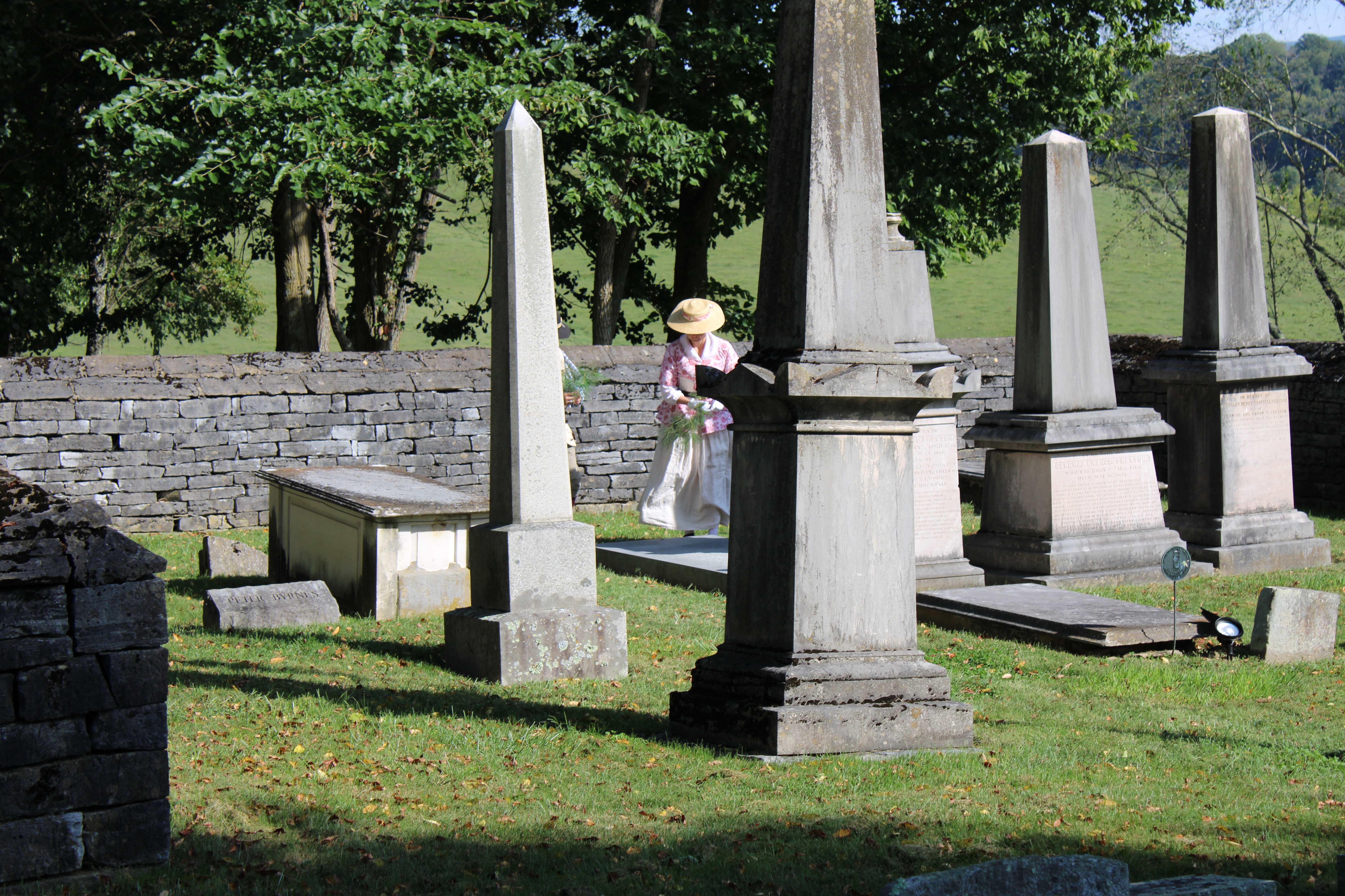 A member of the Blacks Fort Daughters of the American Revolution reenacts a widow paying respects to the grave of William Campbell during a memorial ceremony. Courtesy of Overmountain Victory Trail Association.