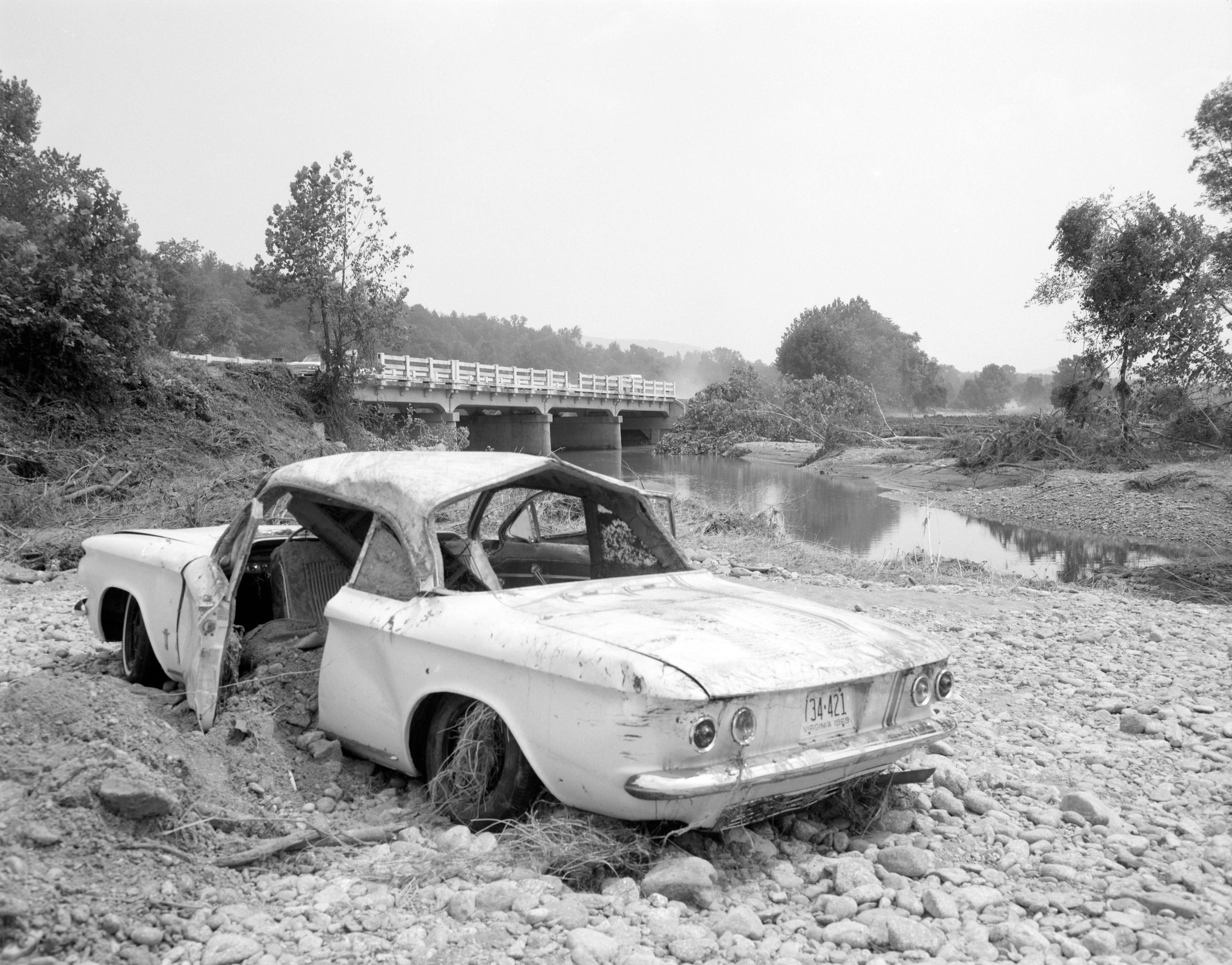 A 1960s-era automobile was wrecked and stranded by the gravel alongside the Tye River in Nelson County, Virginia, in August 1969. Courtesy of Library of Virginia.