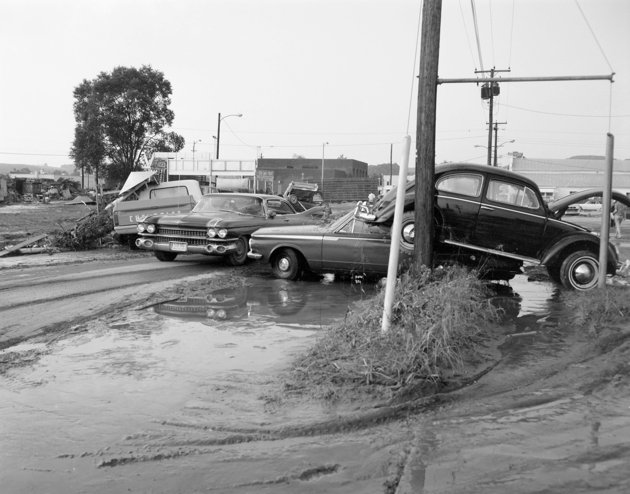 Cars stacked by flooding from Hurricane Camille's remnants in 1969 made it difficult for other vehicles to pass on a roadway at Buena Vista in Rockbridge County. As many as 23 people died in Rockbridge County from Camille flooding, part of a death toll totaling somewhere between 124 and 153, focused most heavily on Nelson County. Courtesy of Library of Virginia.