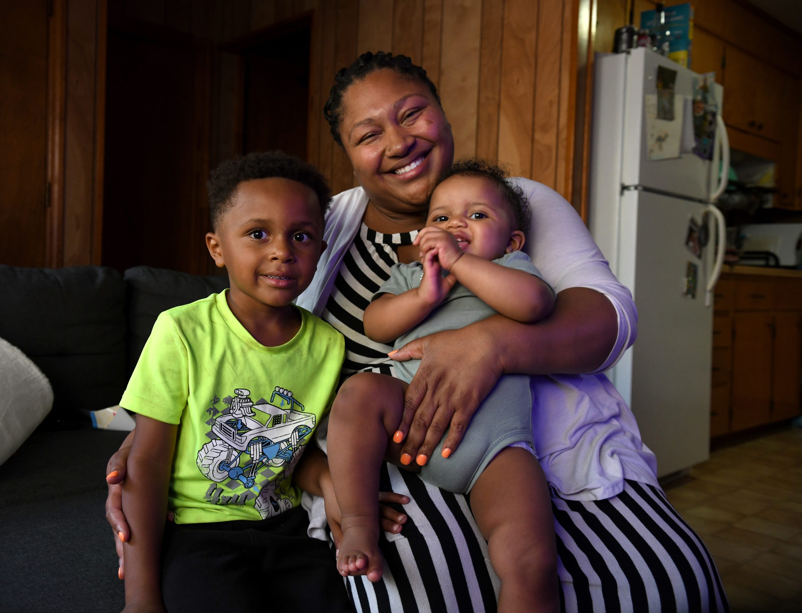 Alexis Ratliff, 29, with her son Ezekiel, 5, and 11-month-old daughter Eleah Witcher in their Rocky Mount home recently. Ratliff had a doula to help with the birth of Eleah. Photo by Natalee Waters.