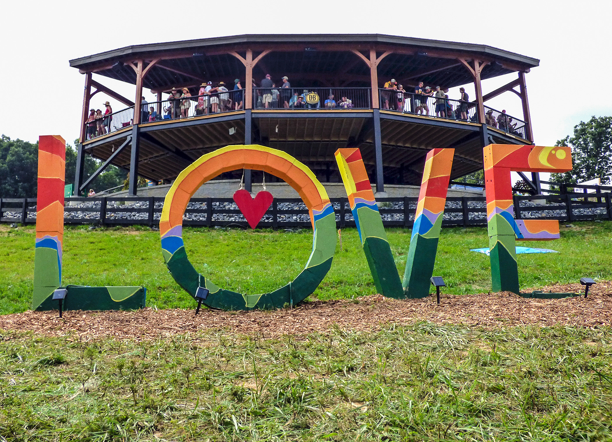 A large LOVE sign in front of a FLoydFest stage