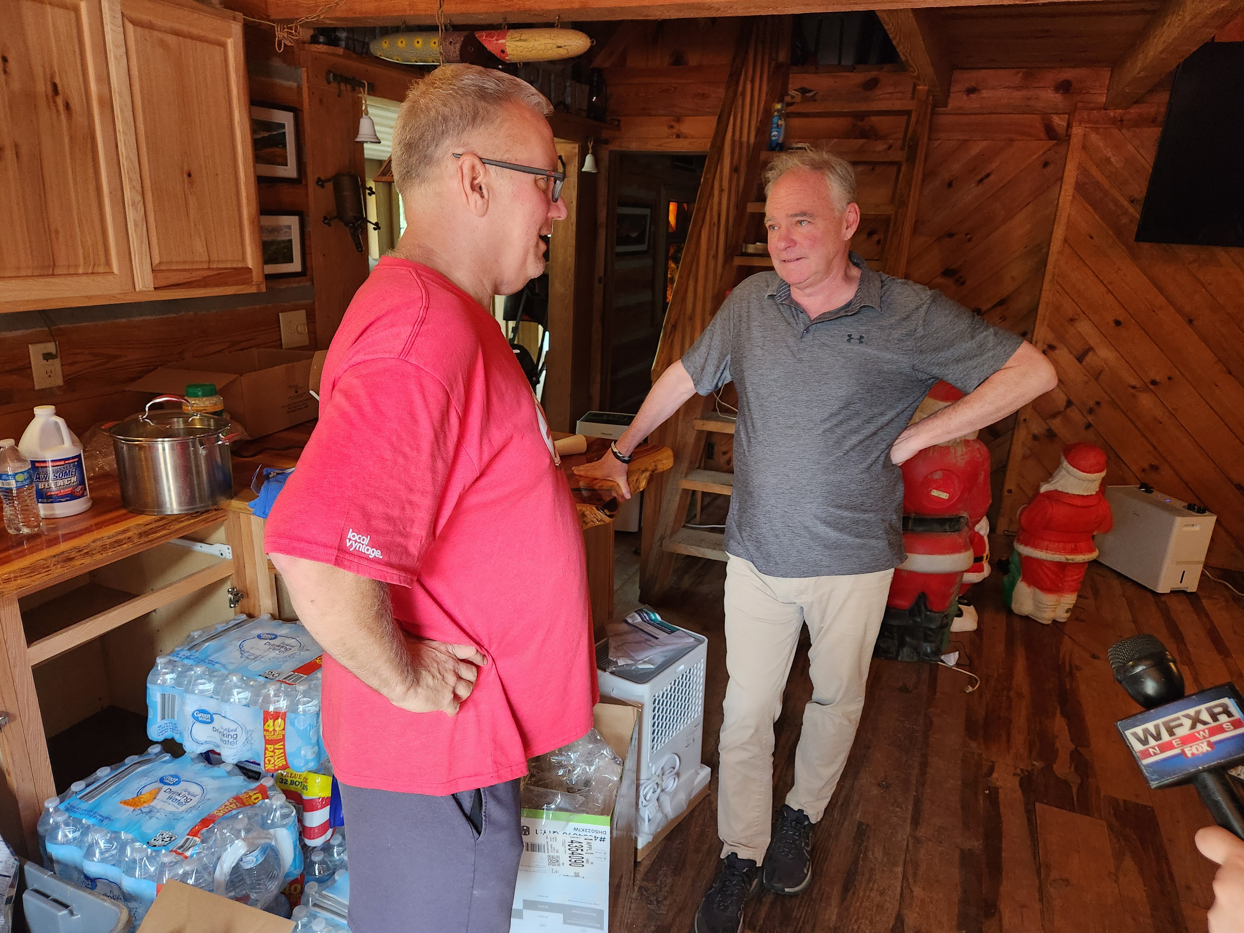 Sen. Tim Kaine, right, talks with homeowner Tim Myers. Photo by Dwayne Yancey