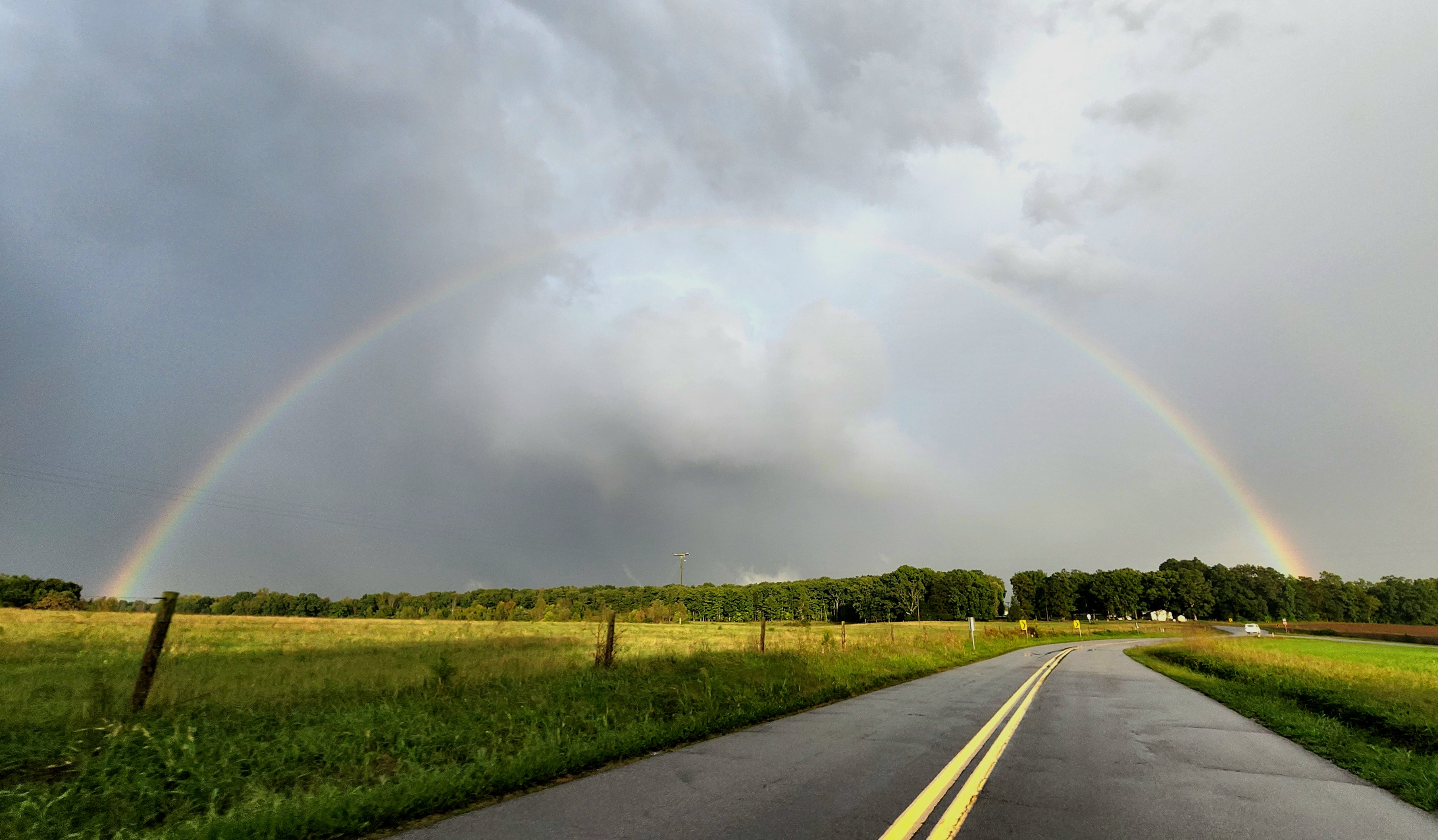 A rainbow arches over a cloud lowering known as a wall cloud with a possible funnel cloud hanging from it near Halifax on Friday as 21 tornado warnings were issued focusing on Southside counties. Courtesy of Tyler Anderson.