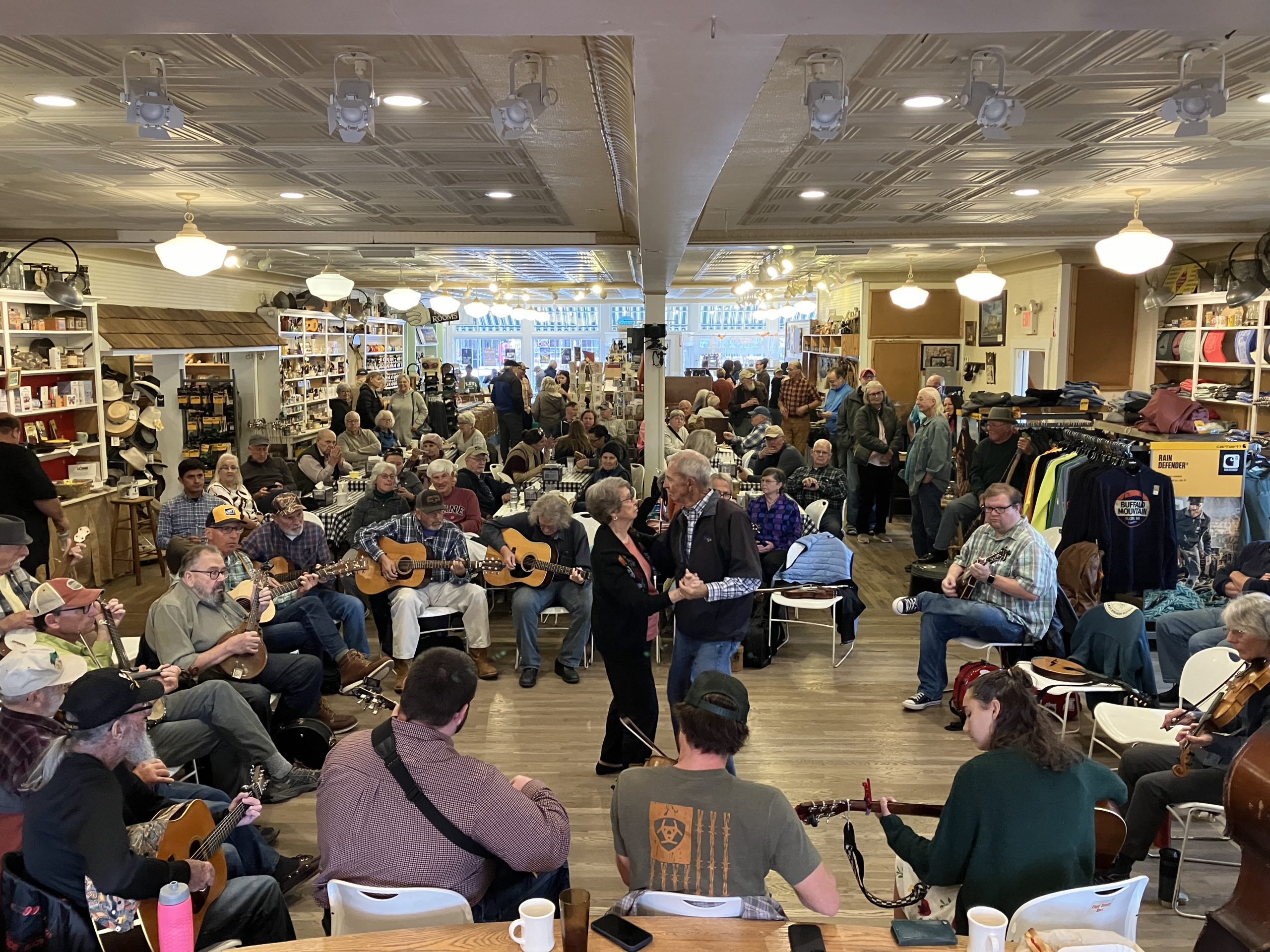 Doris Lawrence and Tom Slusher (center) waltz to a song played during the Sunday afternoon old-time jam session at the Floyd Country Store. Photo by Ralph Berrier Jr.