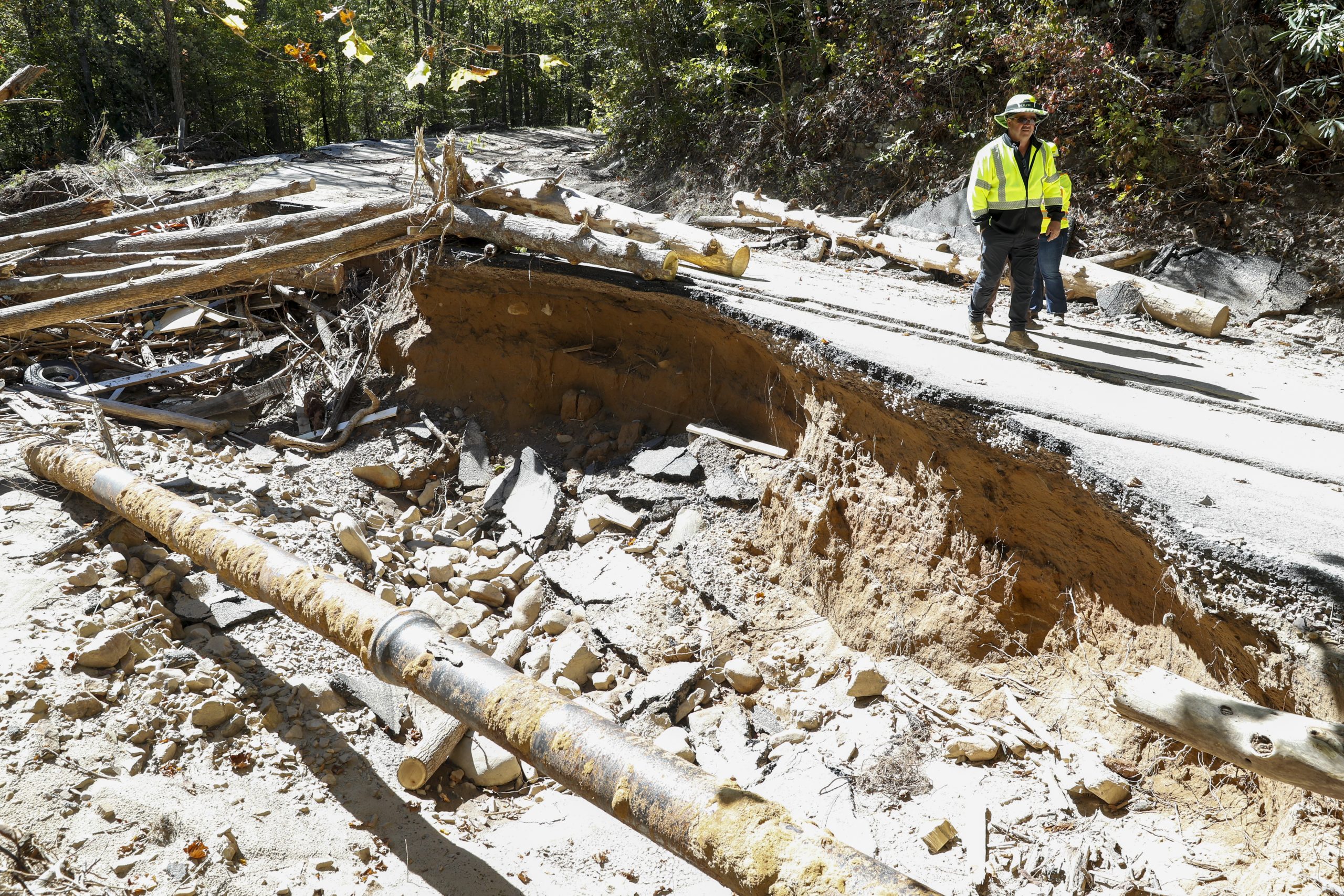 Dennis Sanders (left), assistant environmental manager for the Virginia Department of Transportation, and Michelle Earl, communications manager for VDOT, discuss the damage done to U.S. 58 from floodwaters caused by Hurricane Helene on Sept. 27. Photo by Ben Earp/Ben Earp Photography.