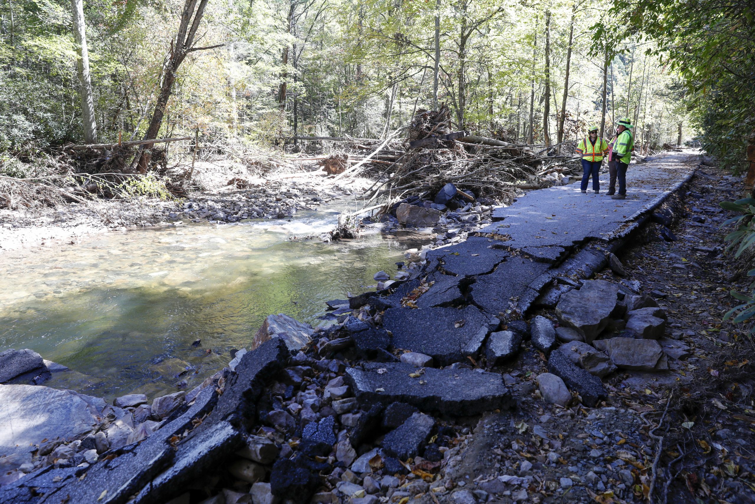 Dennis Sanders (left), assistant environmental manager for the Virginia Department of Transportation, and Michelle Earl, communications manager for VDOT, discuss the damage done to U.S. 58 from flood waters caused by Hurricane Helene. Photo by Ben Earp/Ben Earp Photography.