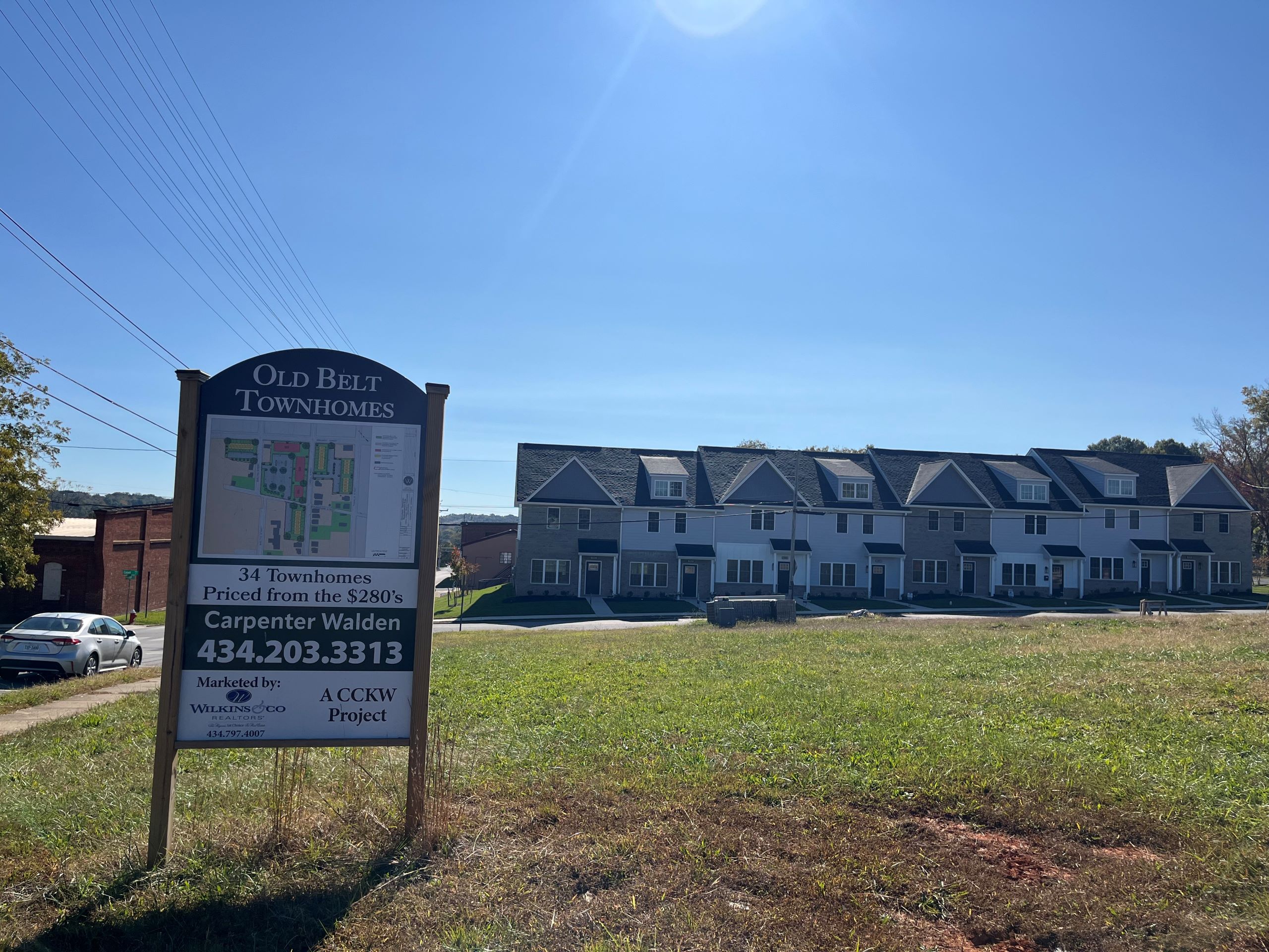 A sign stands in front of a row of townhomes, the Monument Berryman housing project in Danville.