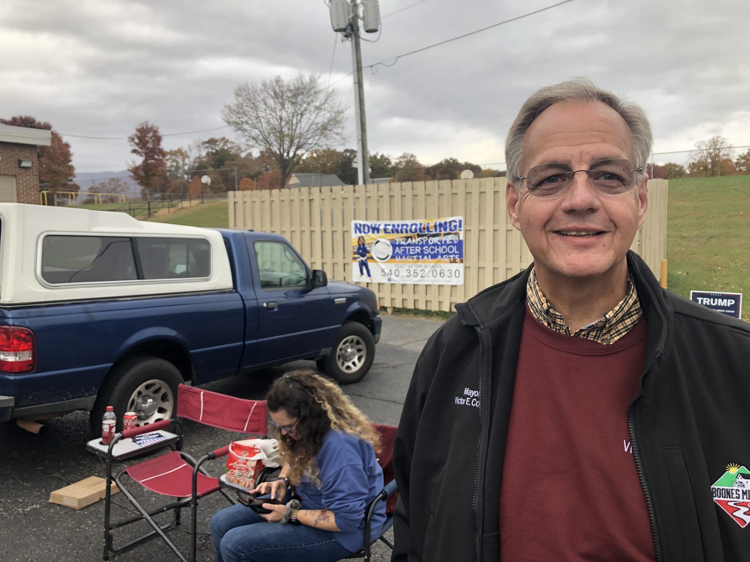 Boones Mill Mayor Victor Conner stands in foreground outside the Boones Mill Elementary School voting precinct.