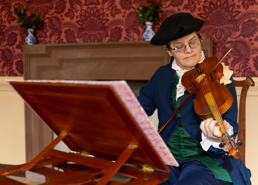 Music interpreter Jennifer Edenborn plays the violin in Colonial Williamsburg. Courtesy of Brendan Sostak, The Colonial Williamsburg Foundation.