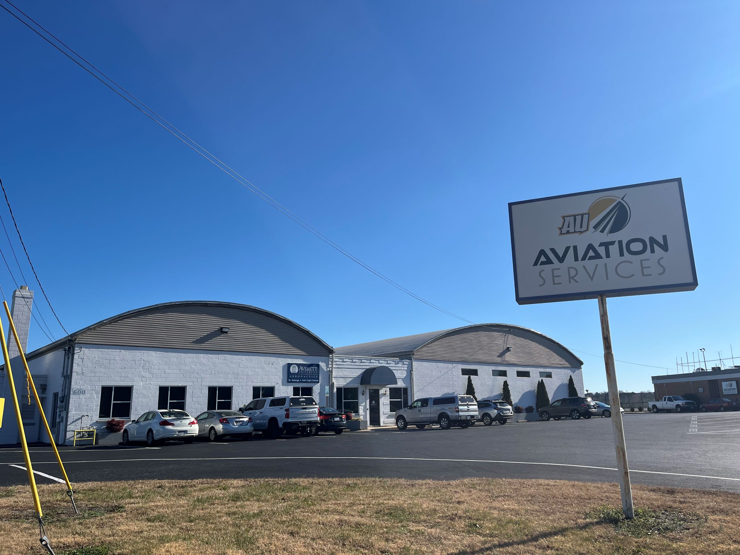 a building at the Danville Regional Airport, with a sign in the foreground that reads "AU Aviation Services."