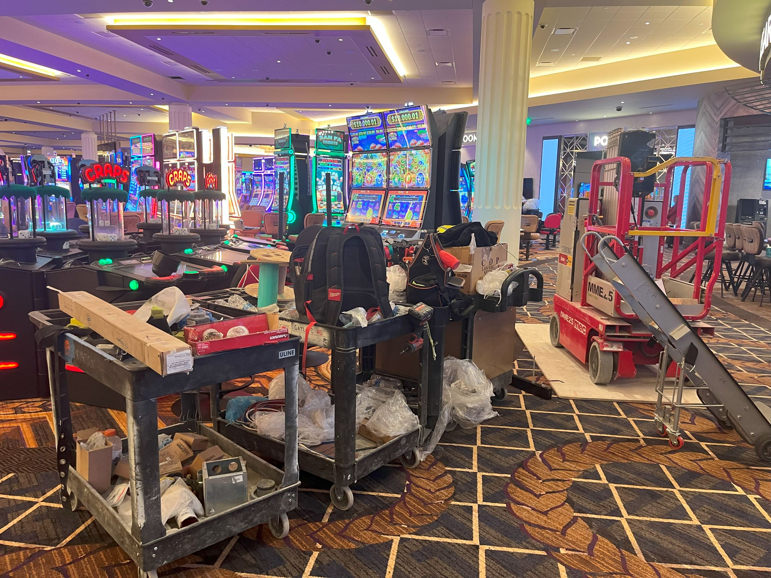 carts with various construction materials and belongings are parked on the gaming floor at Caesars Virginia.