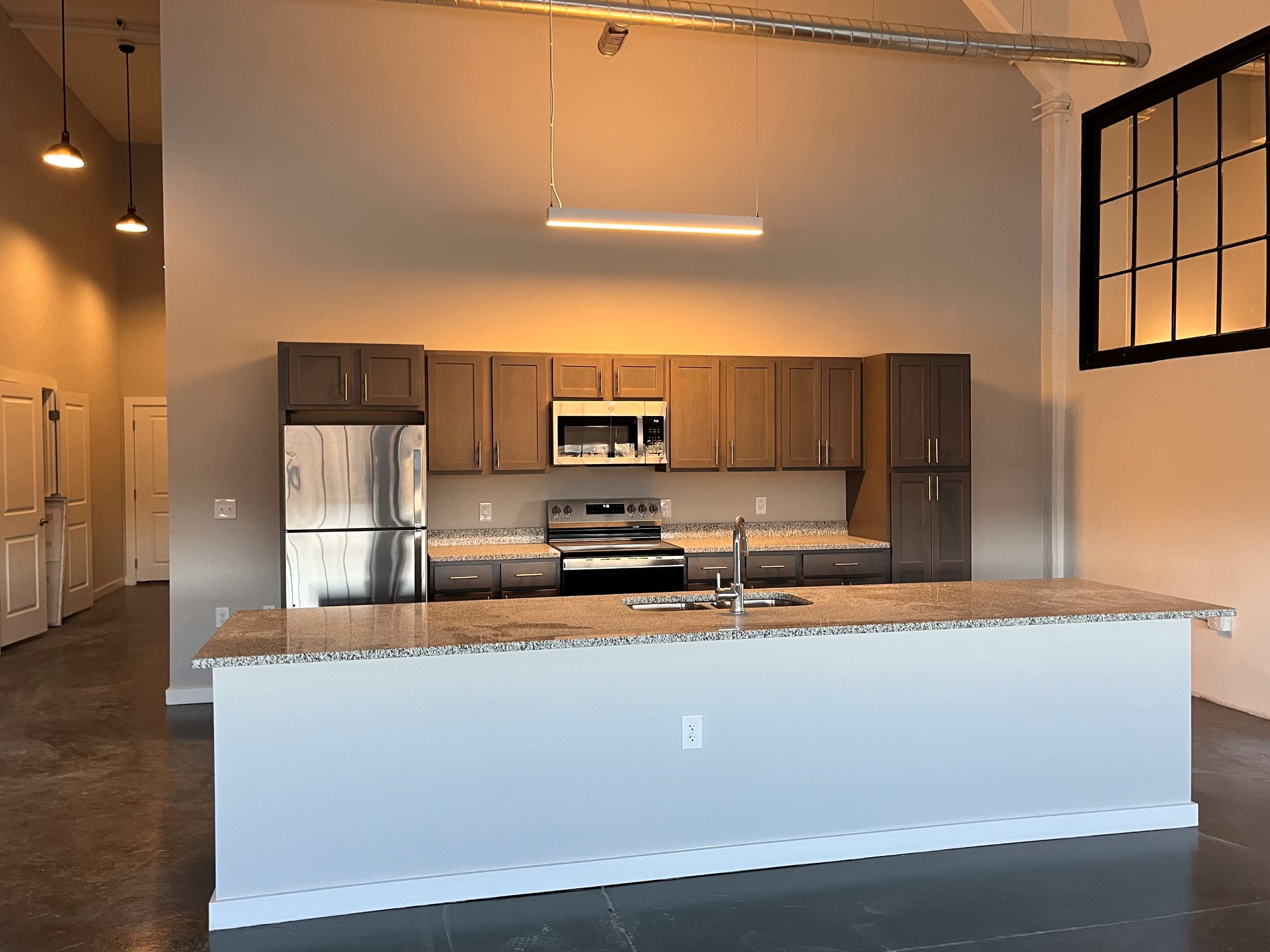 a kitchen inside Dan River Falls in Danville, with new appliances and a large island.