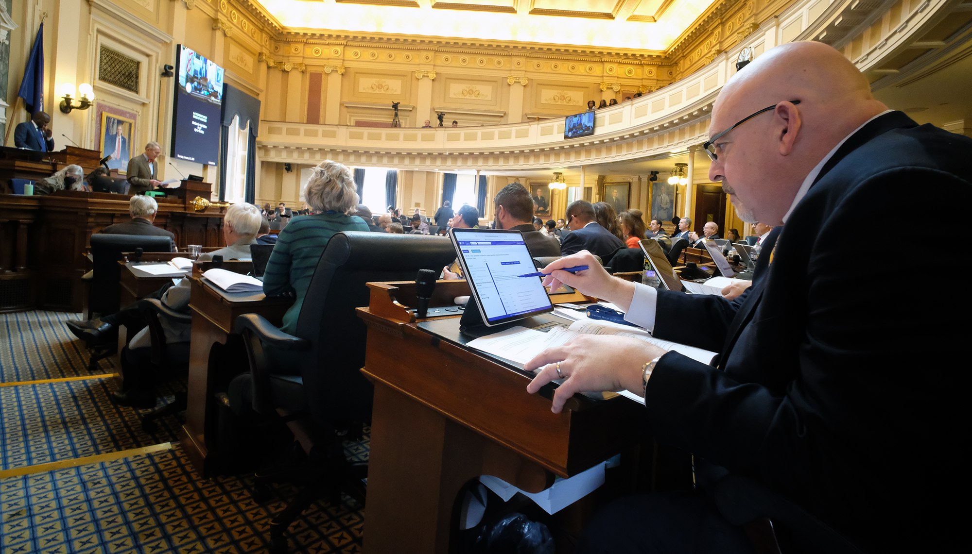 House Minority Leader Todd Gilbert, R-Shenandoah, right, works at his desk in the House of Delegates at the State Capitol in Richmond, VA Thursday, Jan. 23, 2025.