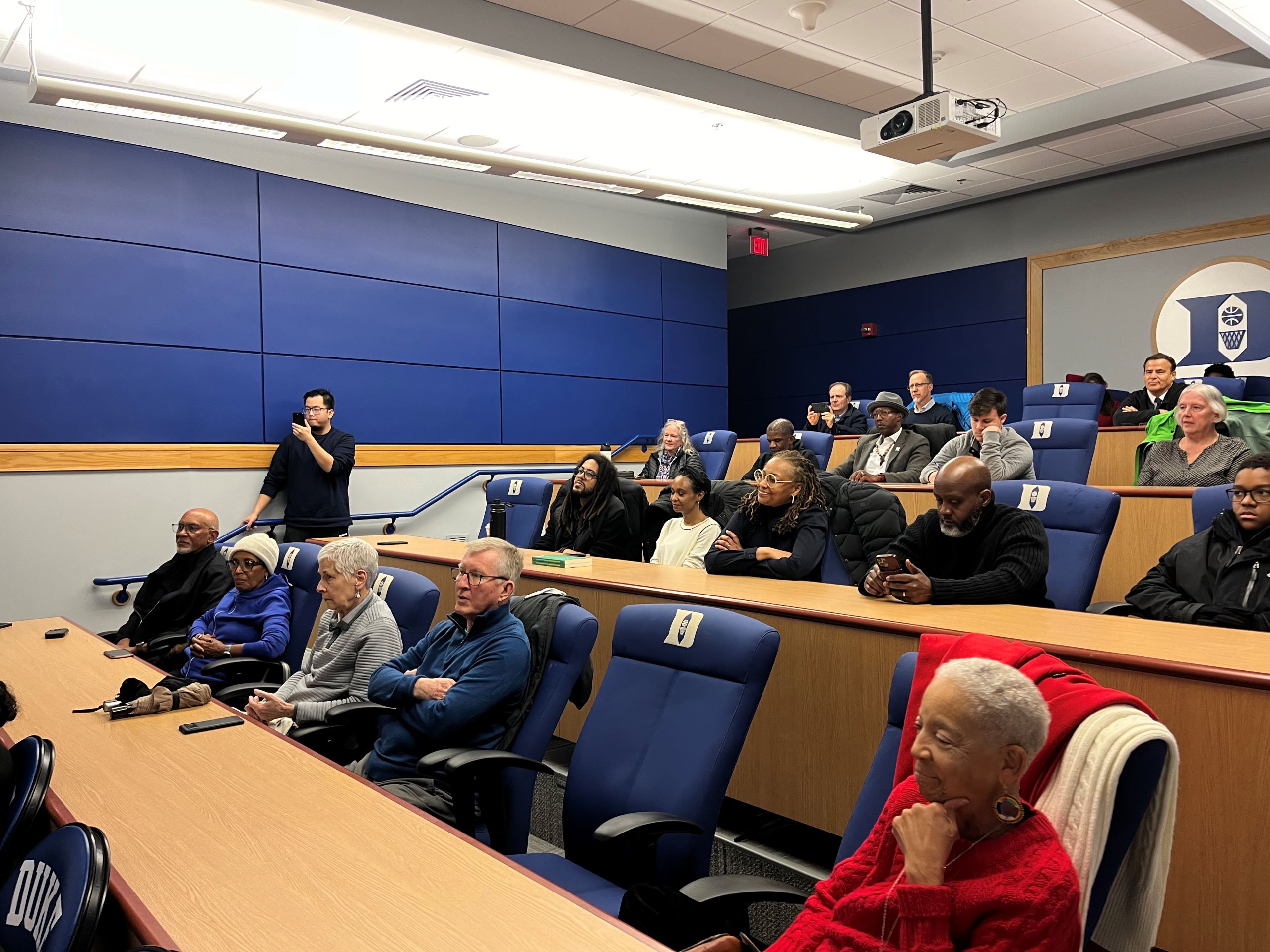 a university seminar room with a small audience, gathered to see a mini documentary about C.B. Claiborne.