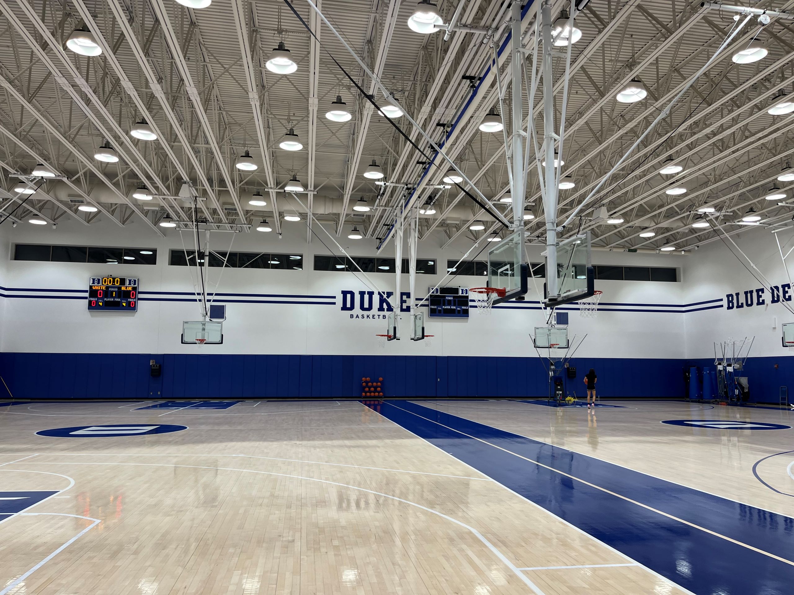 an empty gymnasium with basketball courts on Duke University's campus