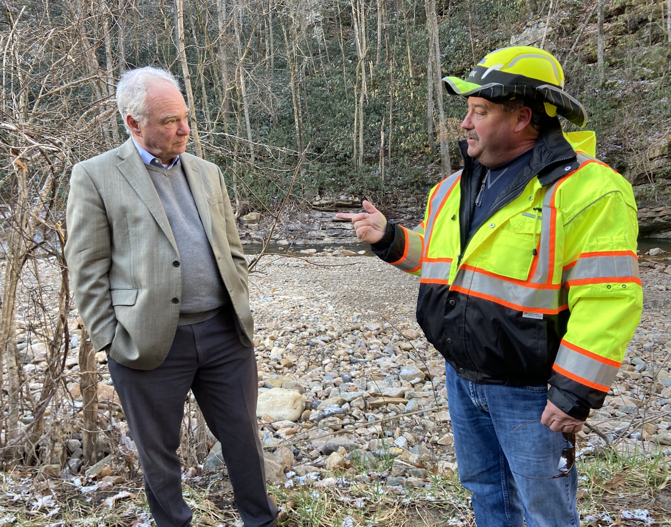 U.S. Sen. Tim Kaine, left, gets a tour of the repairs made to a section of U.S. 58 outside Damascus that was destroyed by Hurricane Helene from Dennis Sanders, right, with the Virginia Department of Transportation. Photo by Susan Cameron.
