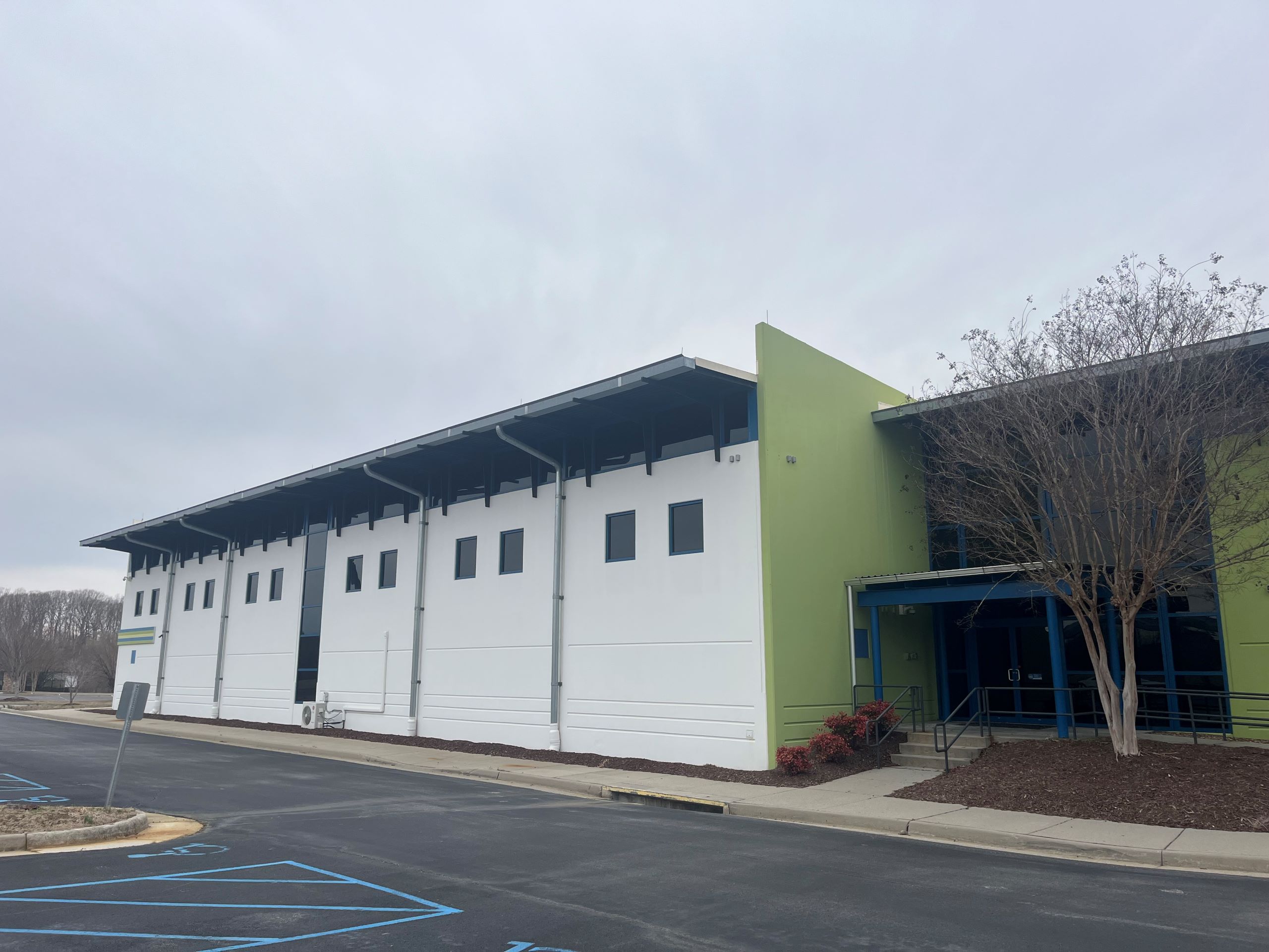 the entrance to a green and white building in a parking lot, the site of a potential pediatric therapy office in Danville