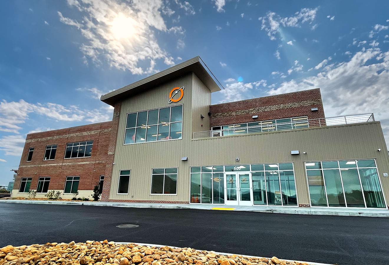 International internet service provider Earthlink's U.S. call center, in Norton, Virginia. The two-story building, at an industrial park serving the Norton and Wise County region, is part brown brick and part beige siding, with lots of windows and a deck on its upper left side. Blue sky and white clouds are in the background. Photo courtesy of Earthlink.