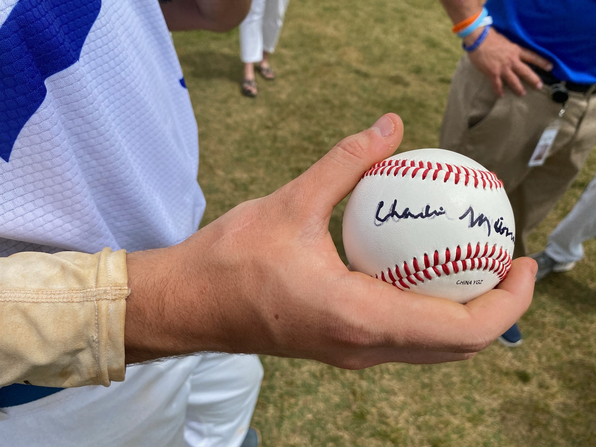 Parry McCluer High senior Braedyn Houck holds a signed baseball from Charlie Manuel after catching the ceremonial first pitch at Saturday’s field dedication. Photo by Robert Anderson.
