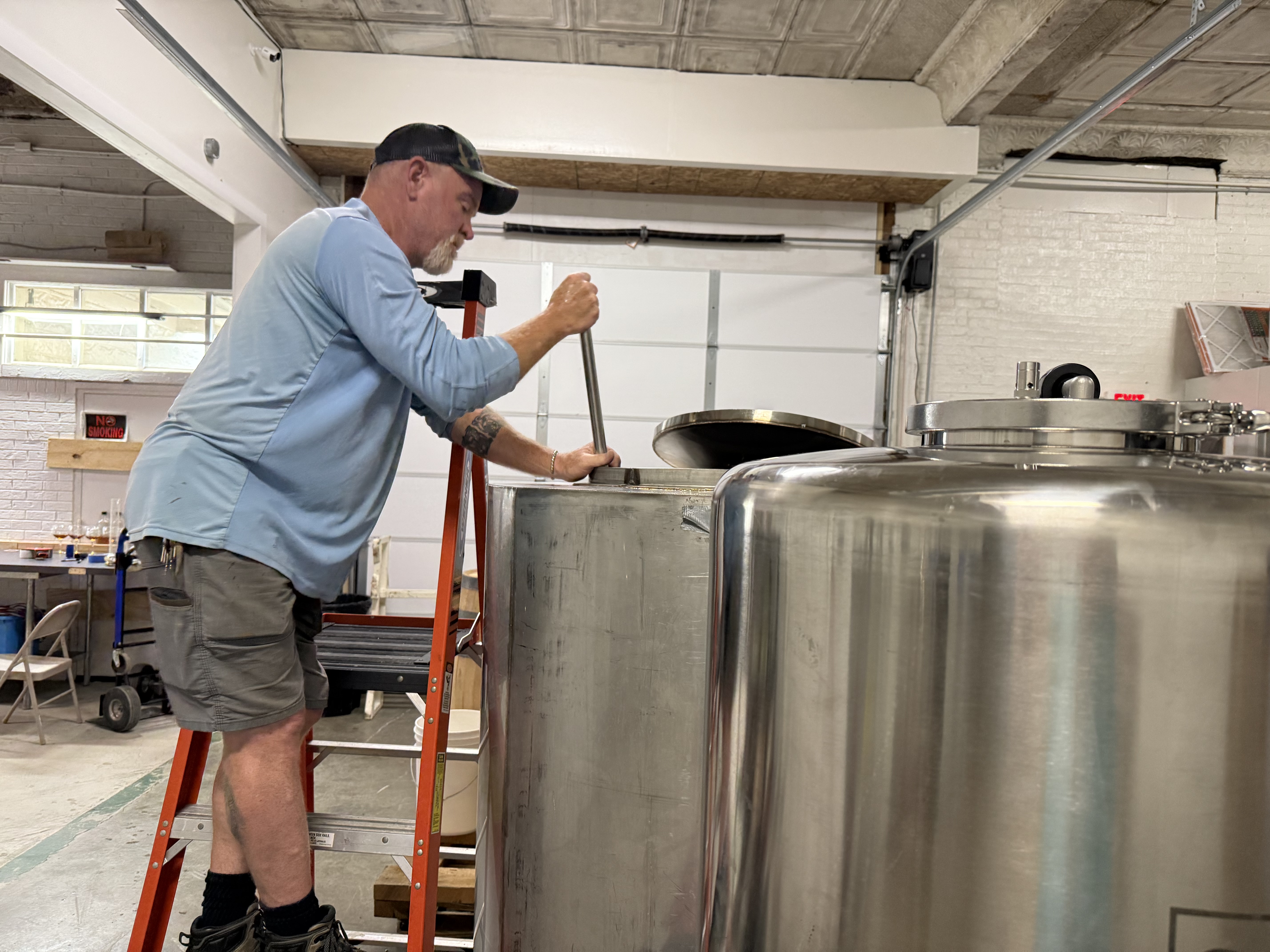 Kevin Forrester, master distiller at Appalachian Heritage Distillery & Brewery in Damascus, is blending whiskies into a large vat and after stirring it and letting it "marry," the Trail Whiskey will be ready to bottle and serve at the Appalachian Trail Days on May 16-18. Photo by Carolyn Wilson.