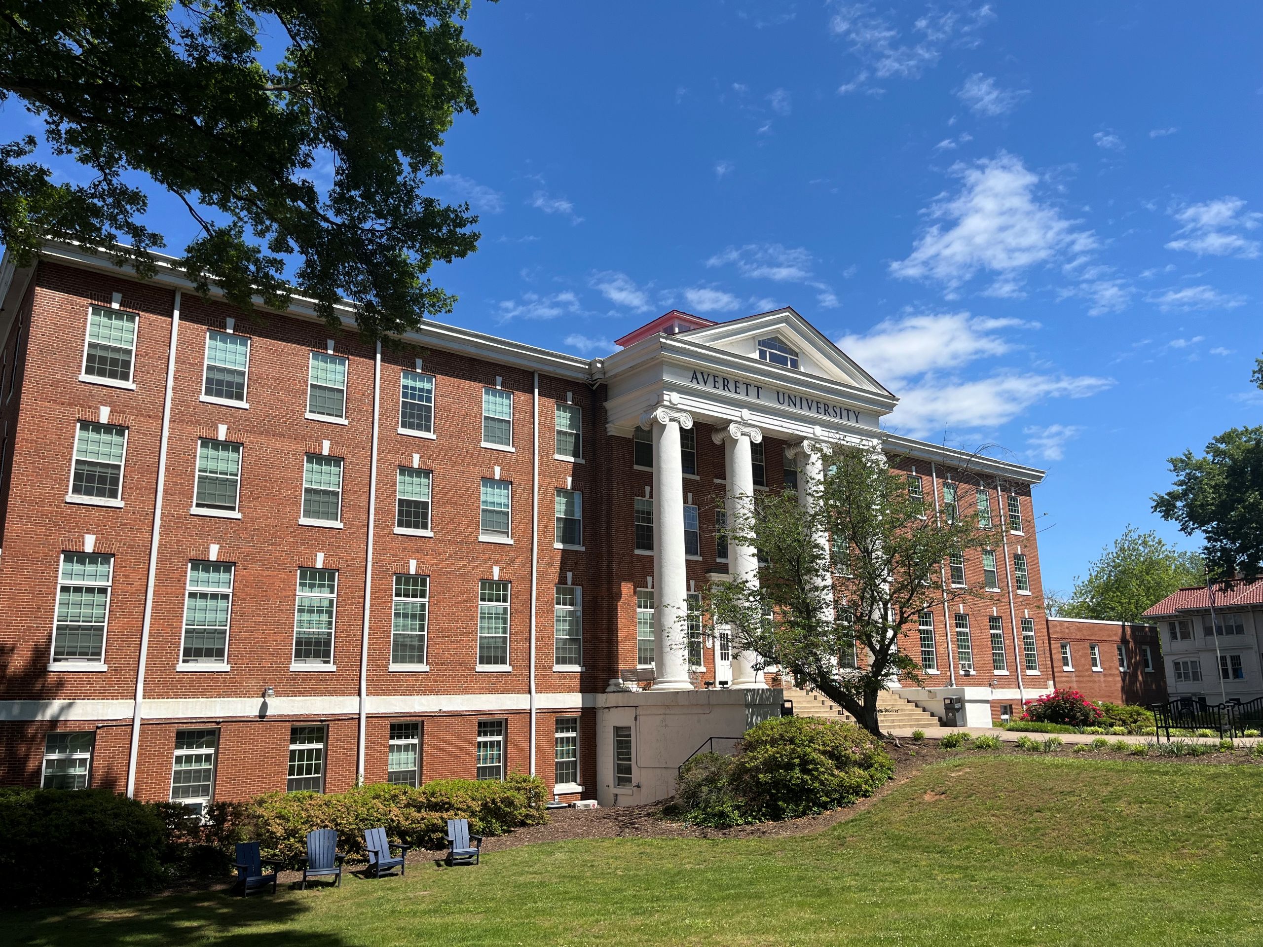 A large brick building with many windows and white columns in front, Averett University in Danville.
