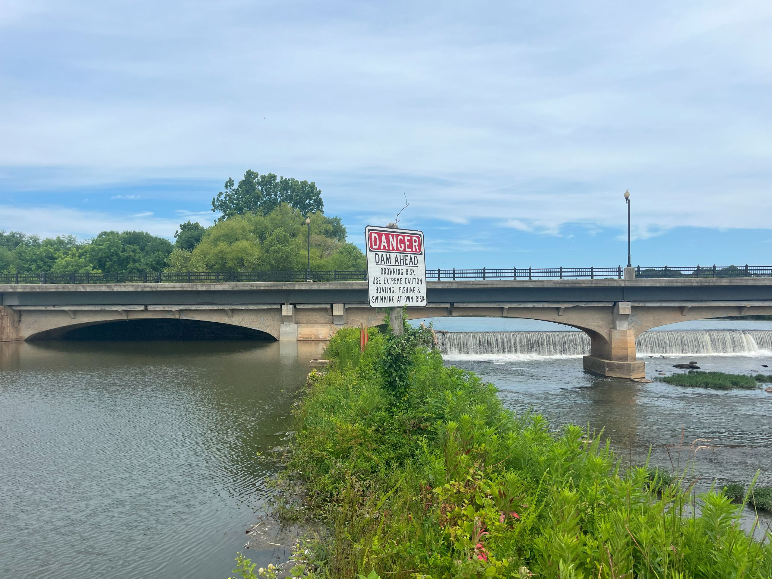 A bridge stretches over the Dan River on the right and the Danville canal on the left, with vegetation in between.