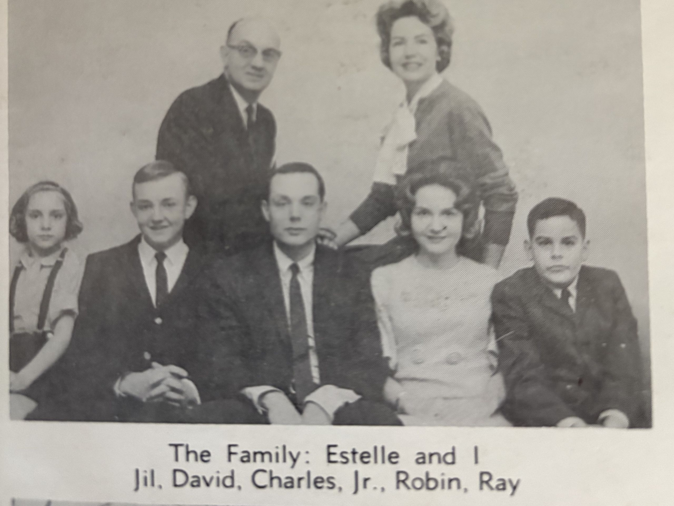 A black and white image of a posed family portrait of the Womack family