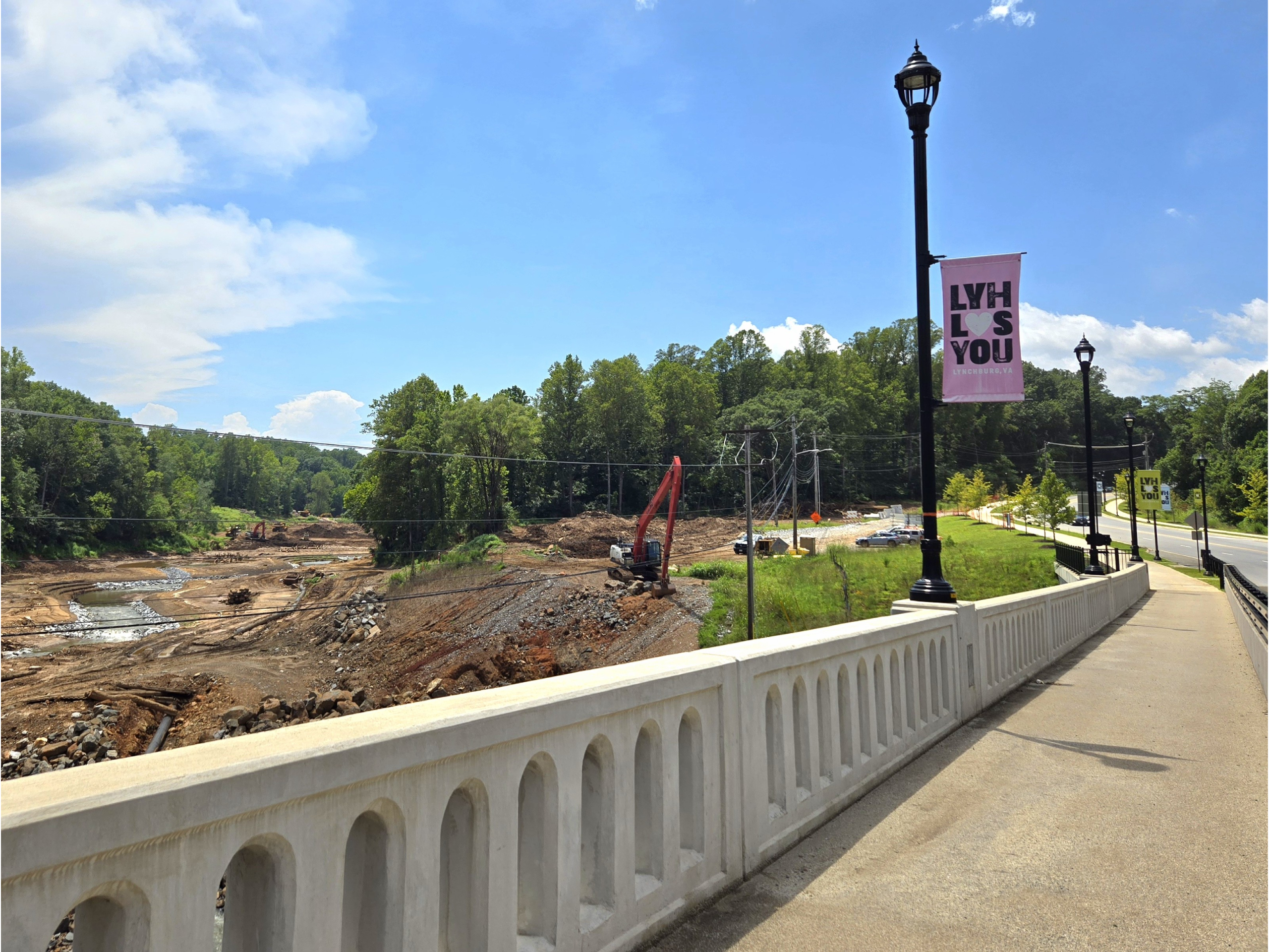 A pedestrian walkway on a bridge overlooks the Blackwater Creek construction site.