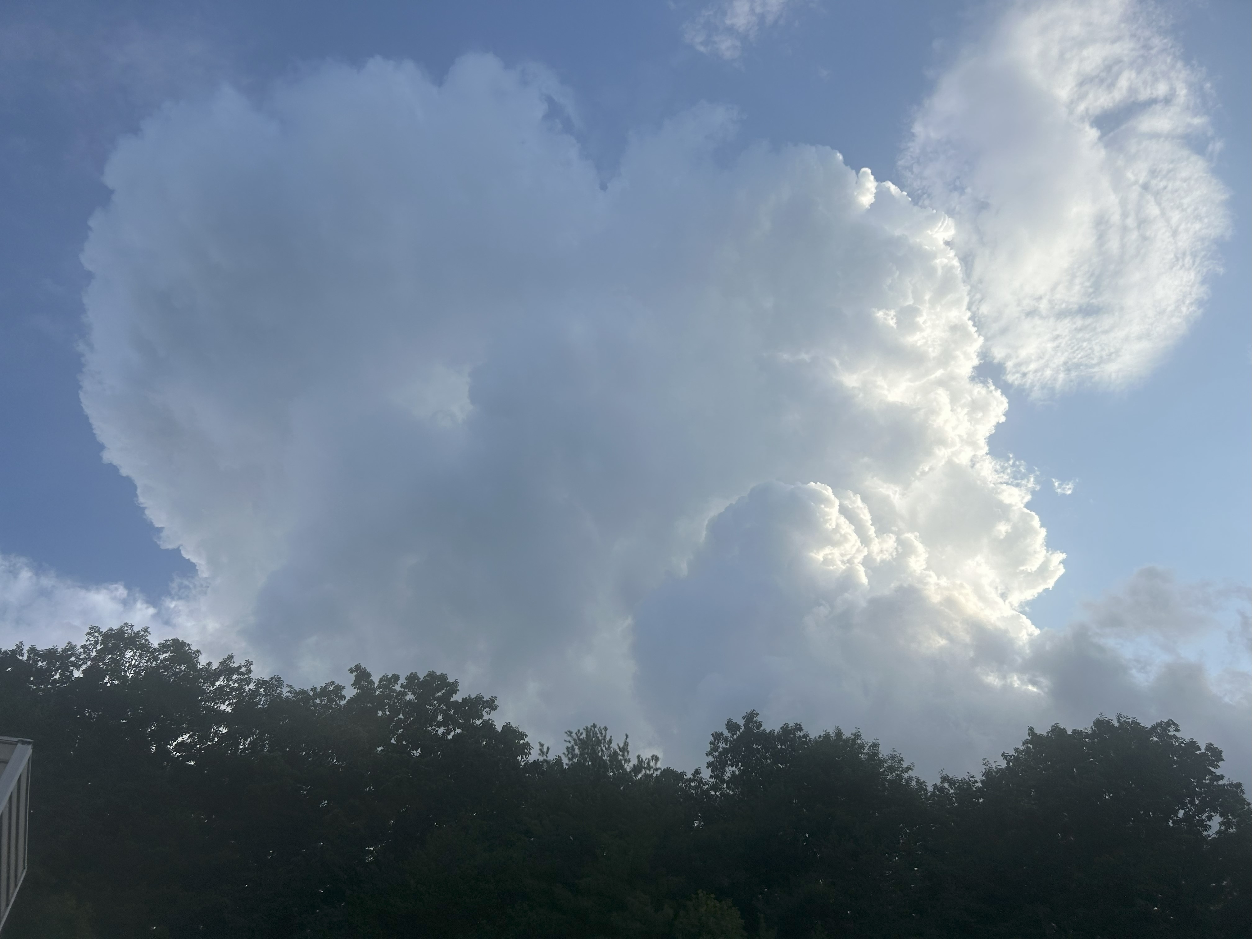 A towering cumulus cloud buillows over a wooded ridge in southern Roanoke County on Monday, June 30. Even though this was not yet producing lightning, this cloud rising into the colder regions where static charge could build in high ice crystals could potentially lead to lightning soon. Photo by Kevin Myatt.