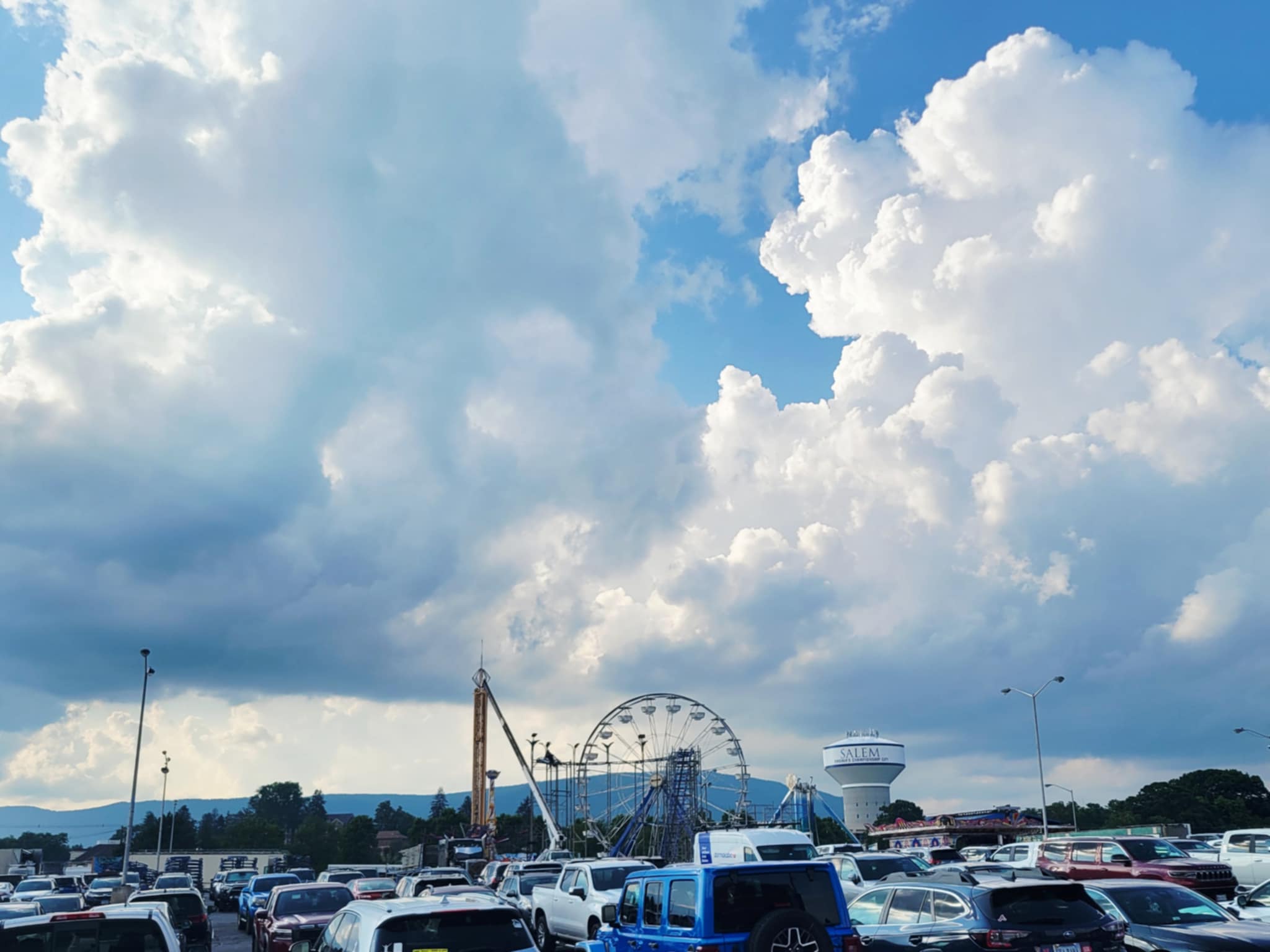 Towering cumulus clouds fill the sky as thunderstorms build around Carilion Clinic Field at Salem Memorial Ballpark on Friday, June 27. The Salem Red Sox game was eventually postponed by lightning and rain. Also visible are some of the rides being constructed ahead of the Salem Fair, which begins on Wednesday, July 2. Courtesy of Christine Saunders.