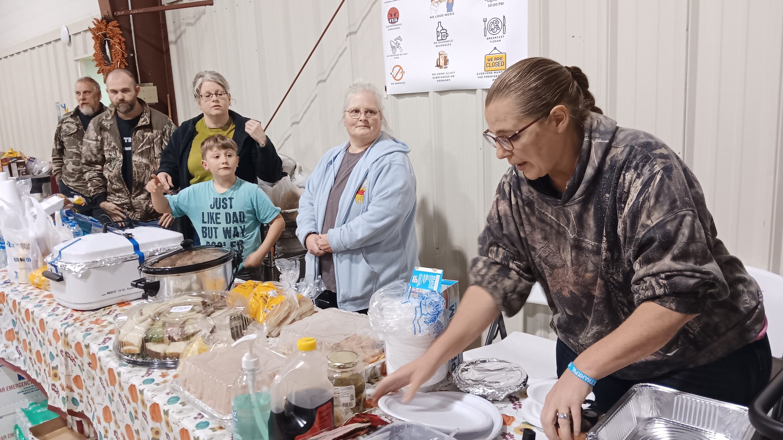 A group of volunteers help distribute meals during a particularly cold December night.
