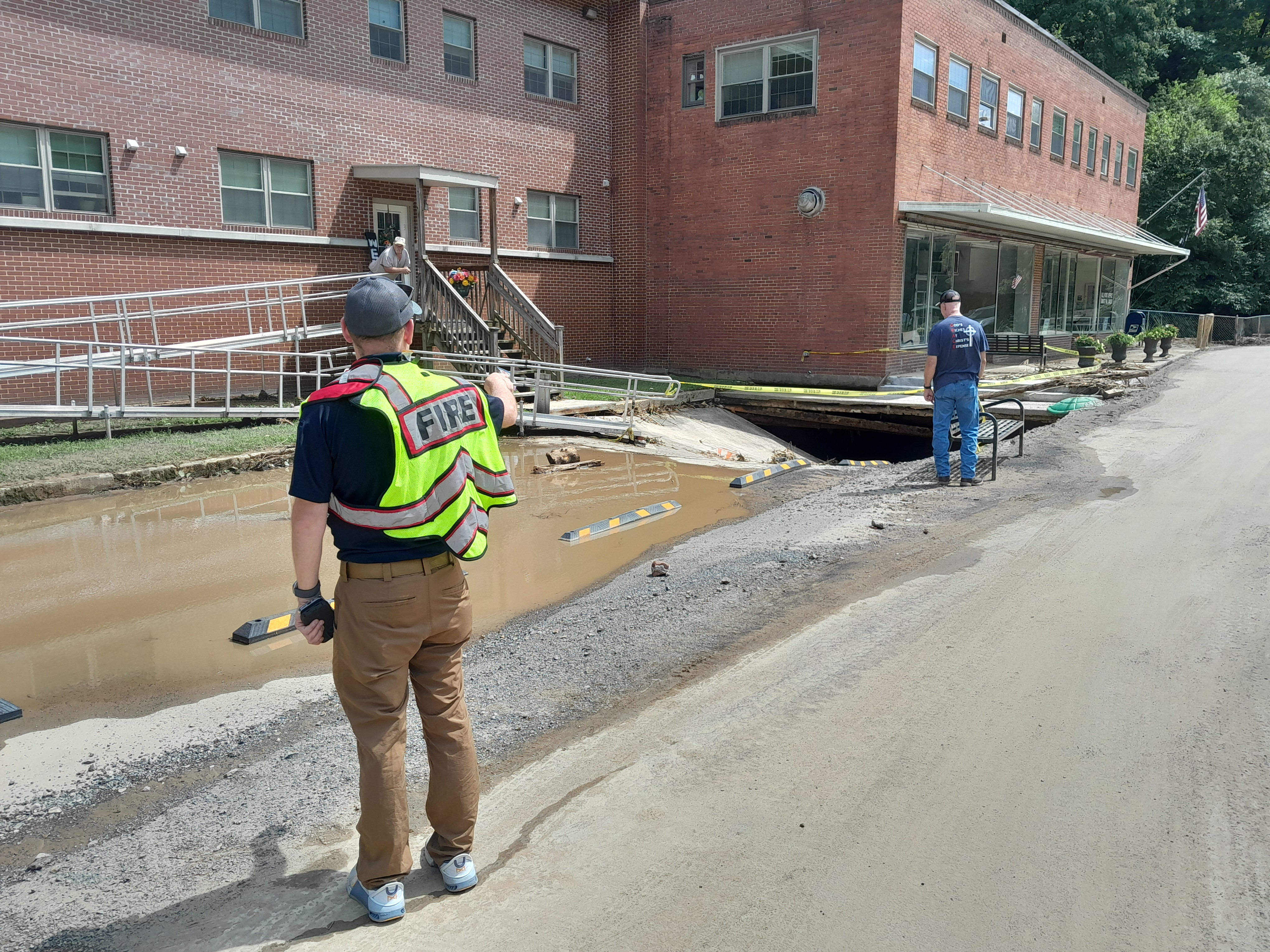 St. Paul Fire Department emergency medical services Capt. Wesley Lawson points to broken concrete exposing a culvert into which a woman caught in floodwaters floated. She was rescued after floating about 2,000 feet downstream. Photo by Jeff Lester.
