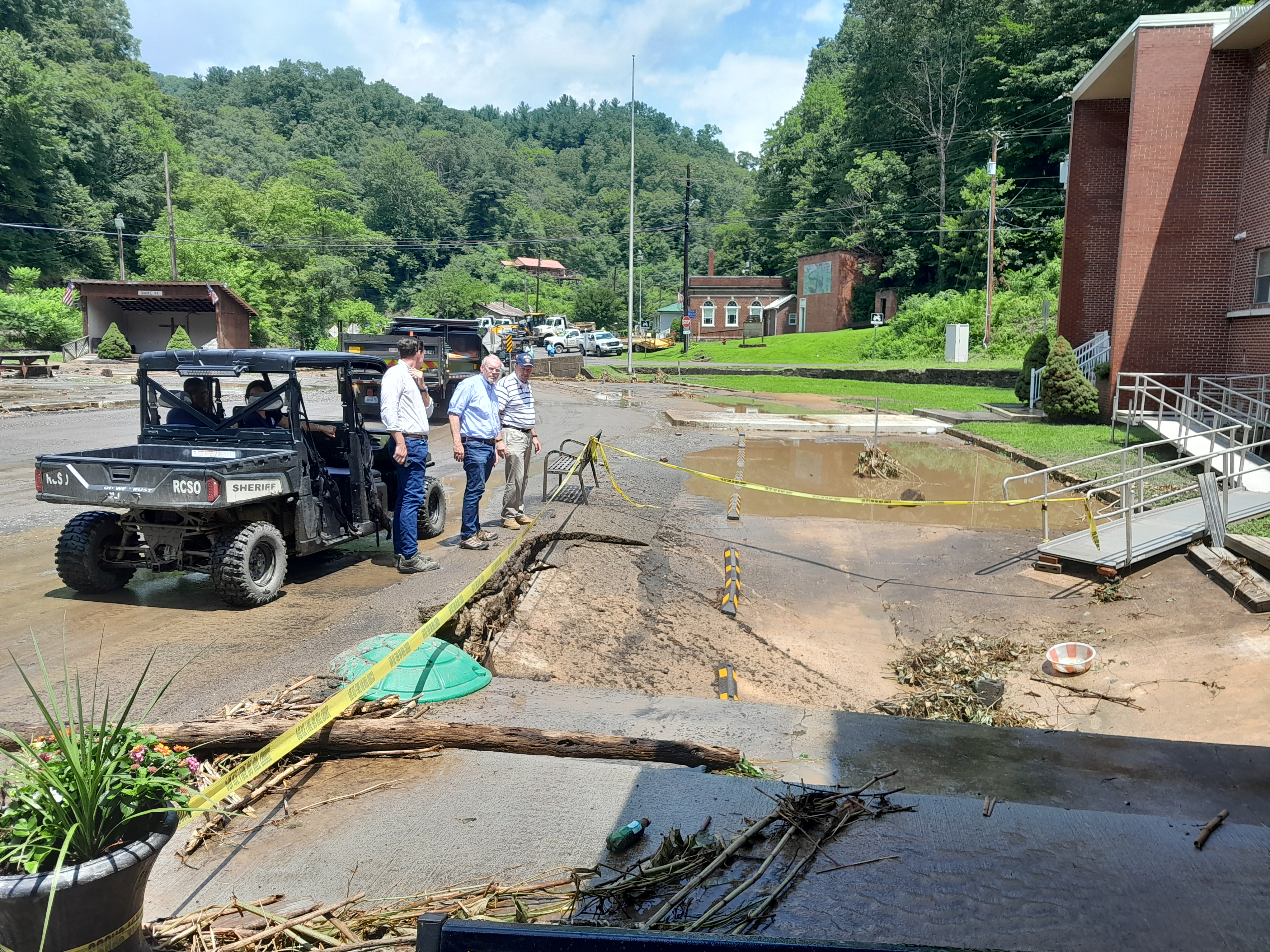 Rep. Morgan Griffith looks at the broken cap above a culvert at an apartment building where floodwaters were an estimated three feet high. Photo by Jeff Lester.