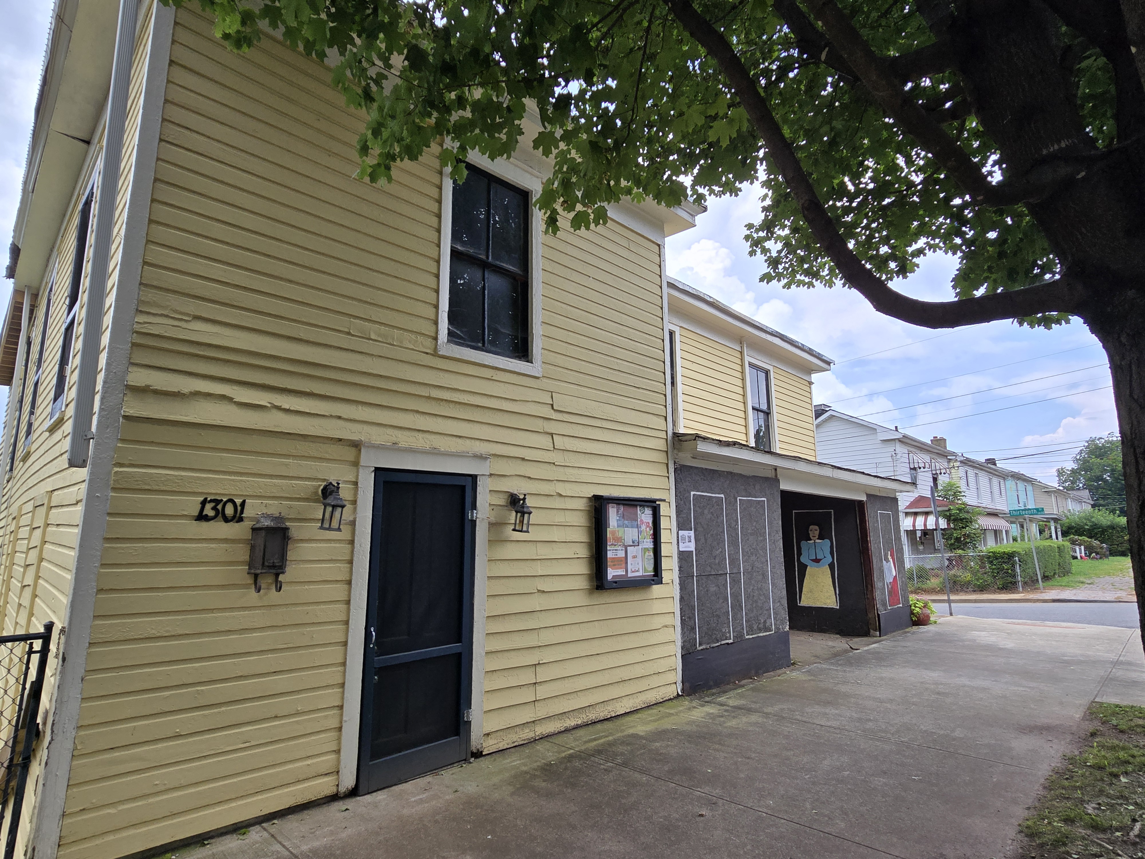 A yellow grocery store sits on the corner of Pierce Street.