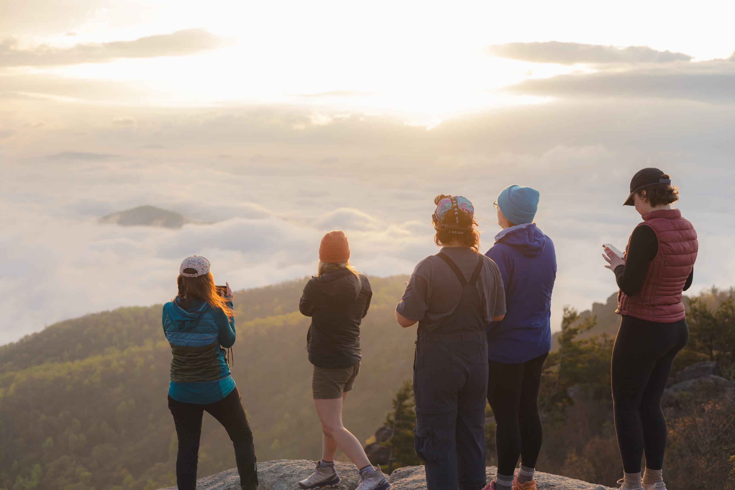Group of hikers admire a cloud inversion sunrise on Old Rag. Courtesy of Jenn Loving Wade.