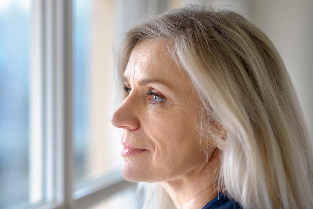 a woman contemplates her Acute myeloid leukemia diagnosis