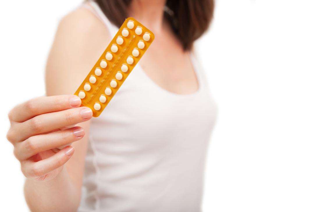 woman holding birth control and wondering about the long term effects of birth control