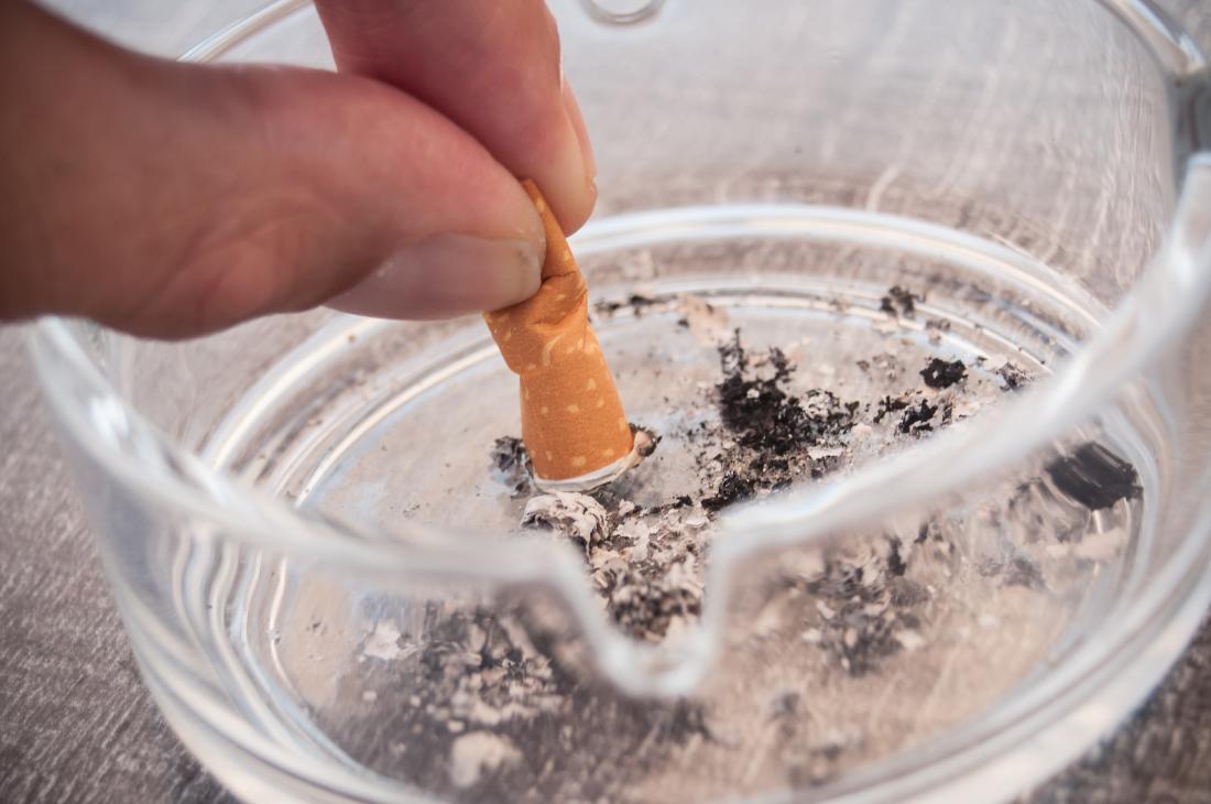 Putting a cigarette out in an ashtray