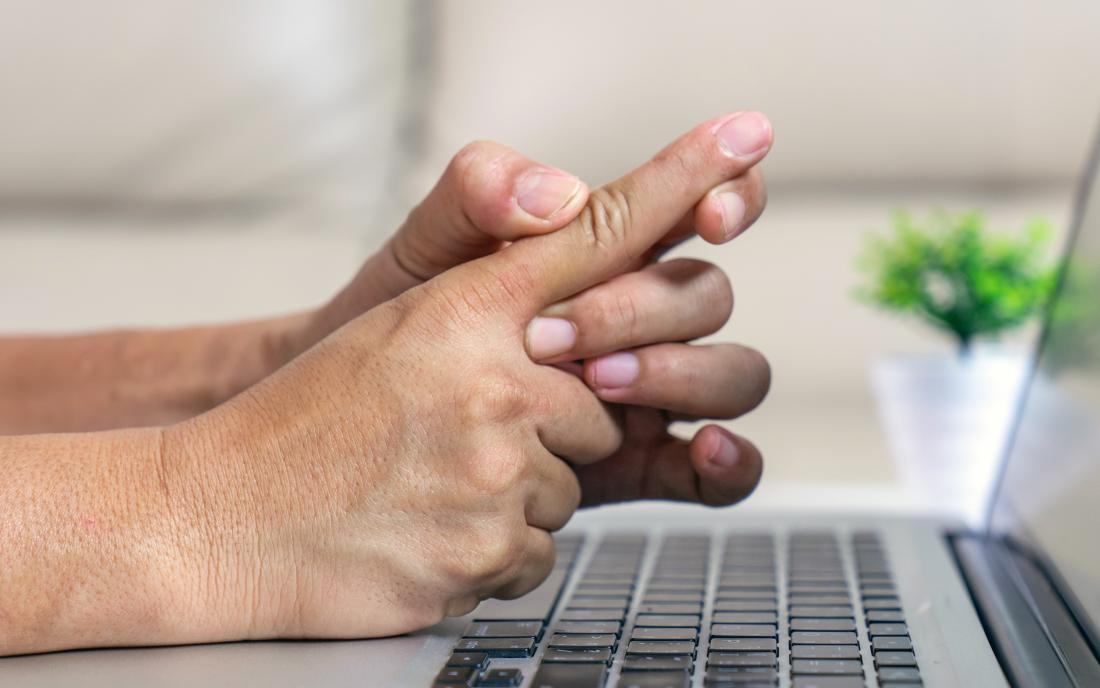 a person holding their finger because they have trigger finger. 