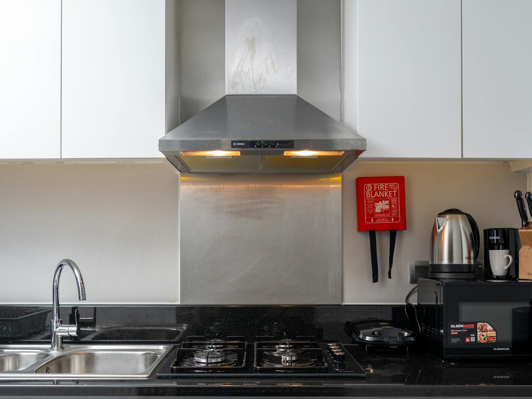 Contemporary kitchen design featuring stainless steel appliances and a sleek finish.