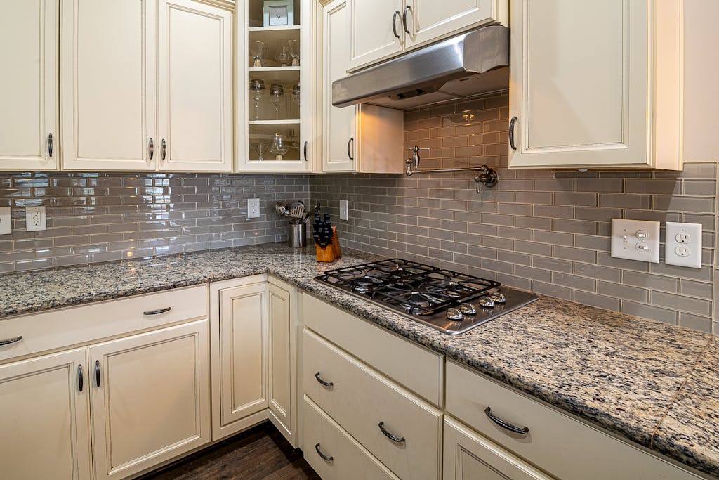 Stylish kitchen featuring granite countertops, stainless steel stove, and modern cabinetry for a sleek design.