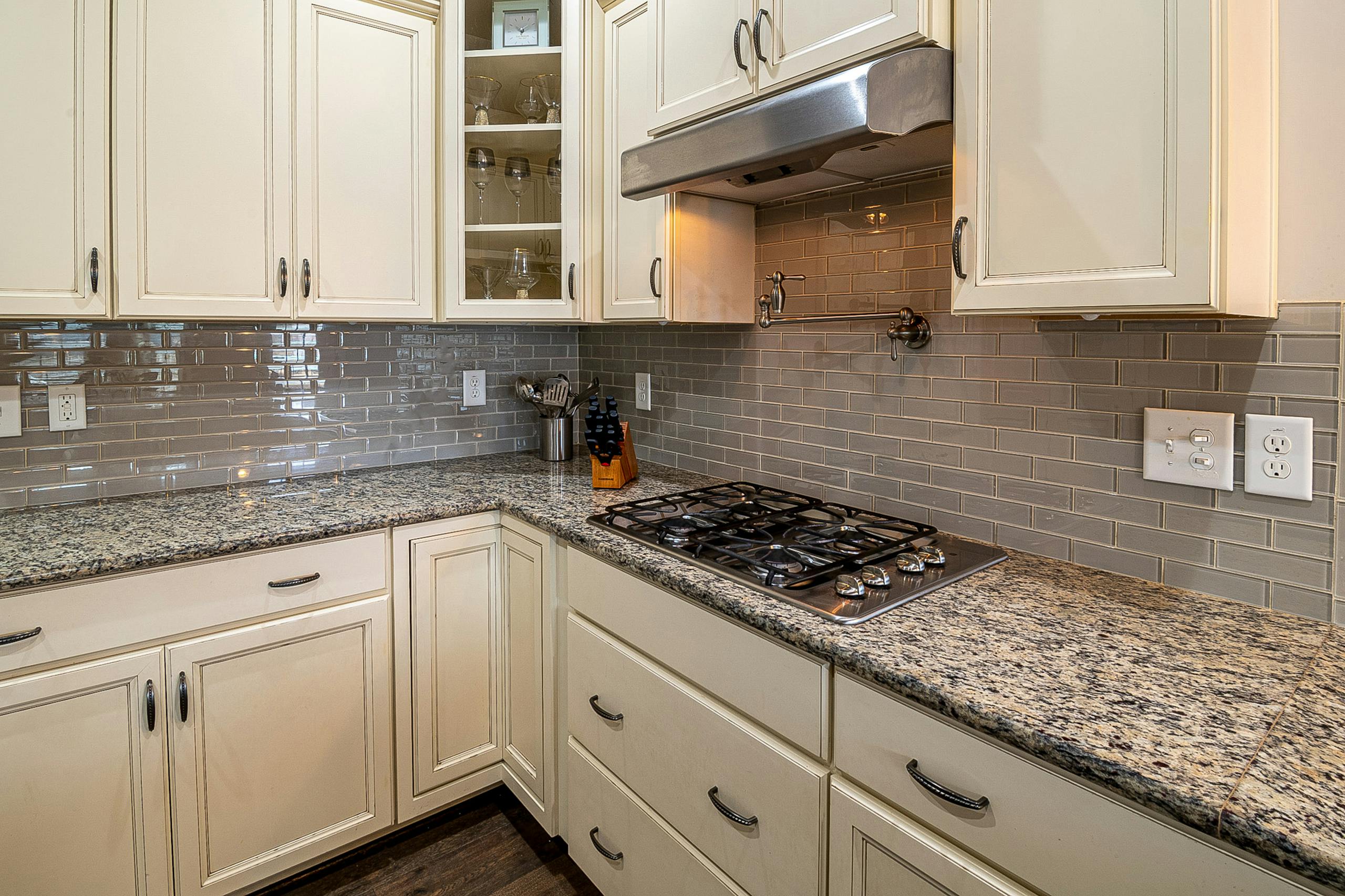 Stylish kitchen featuring granite countertops, stainless steel stove, and modern cabinetry for a sleek design.