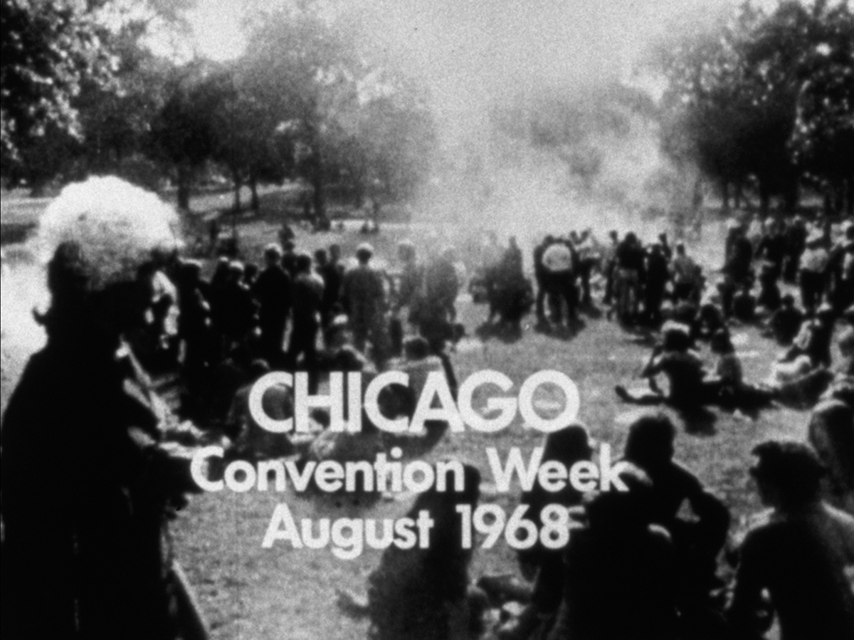 a black-and-white film still of protesters with the text "CHICAGO Convention Week August 1968"