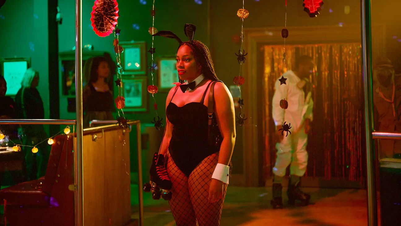 a Black woman at a rollar rink in a Playboy Bunny costume