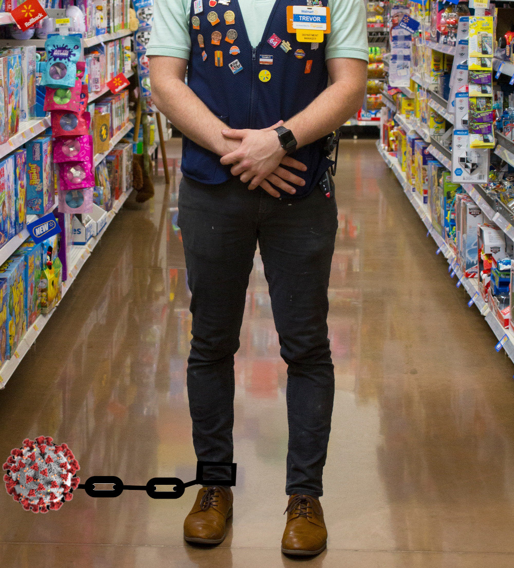 A Walmart employee standing in a store aisle; there's a ball-and-chain attached to his ankle; the ball has been replaced by a covid-19 virus.