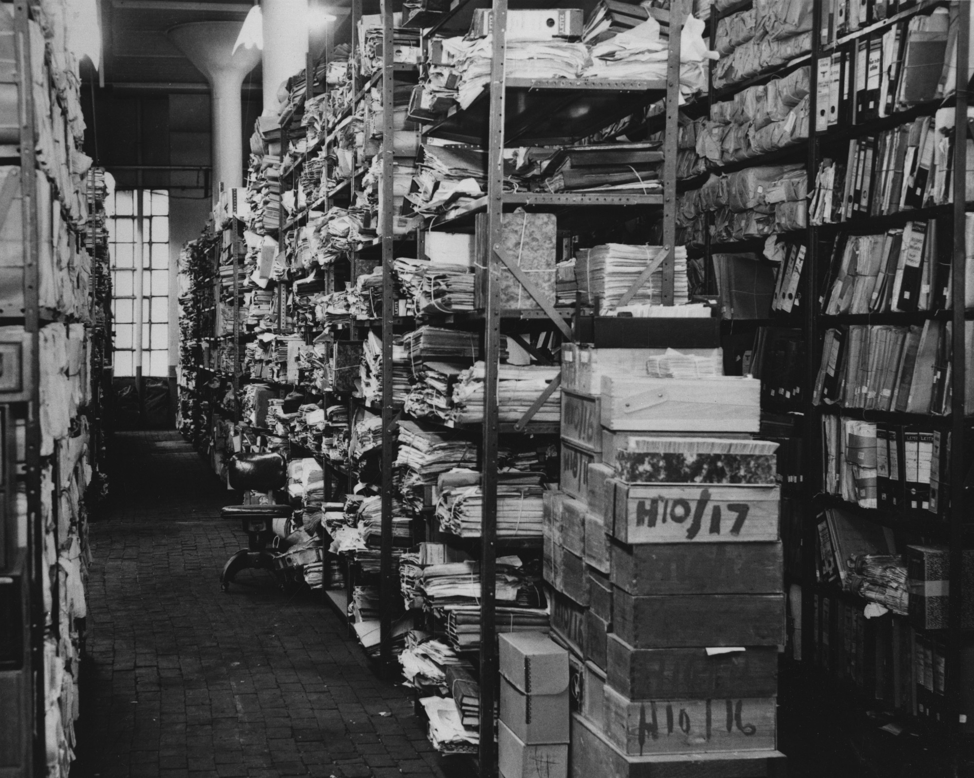 A photograph of the Military Records Center in Alexandria, Virginia. Displayed are some captured German records waiting to be boxed.