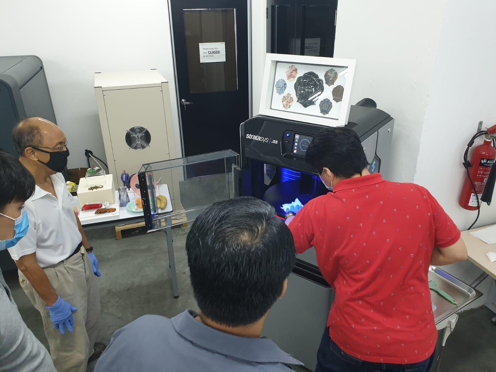 Showing the Stratasys J55 print tray with printed parts.