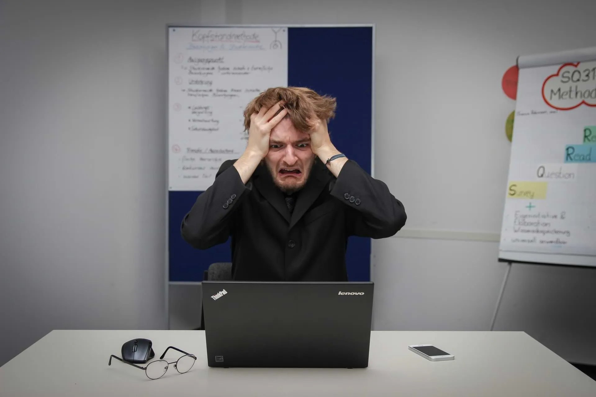 Photo of Frustrated Man Holds Head